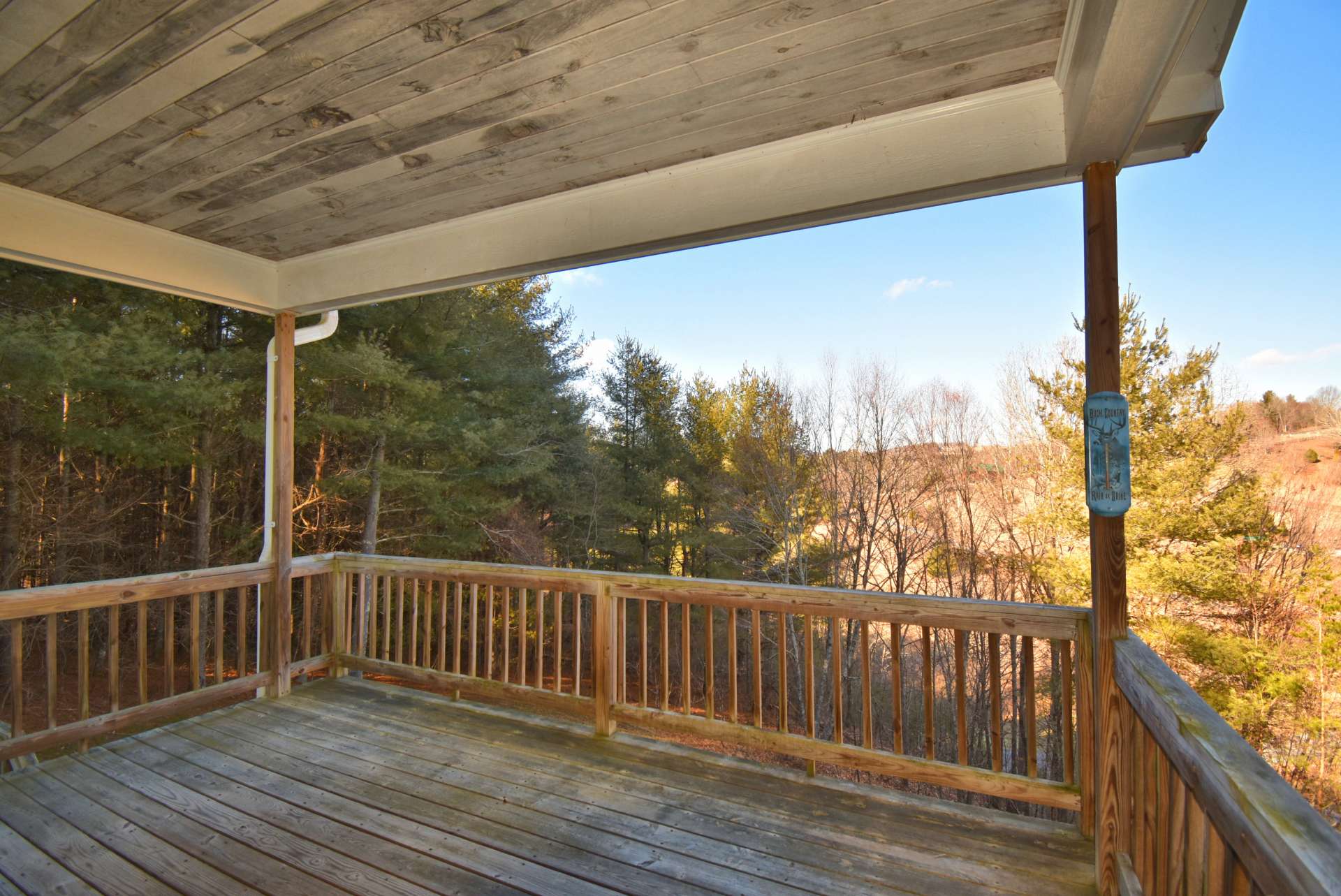 The back of the house is very private featuring a connected top and lower deck overlooking a neighboring pond and exceptional views of distant mountains.