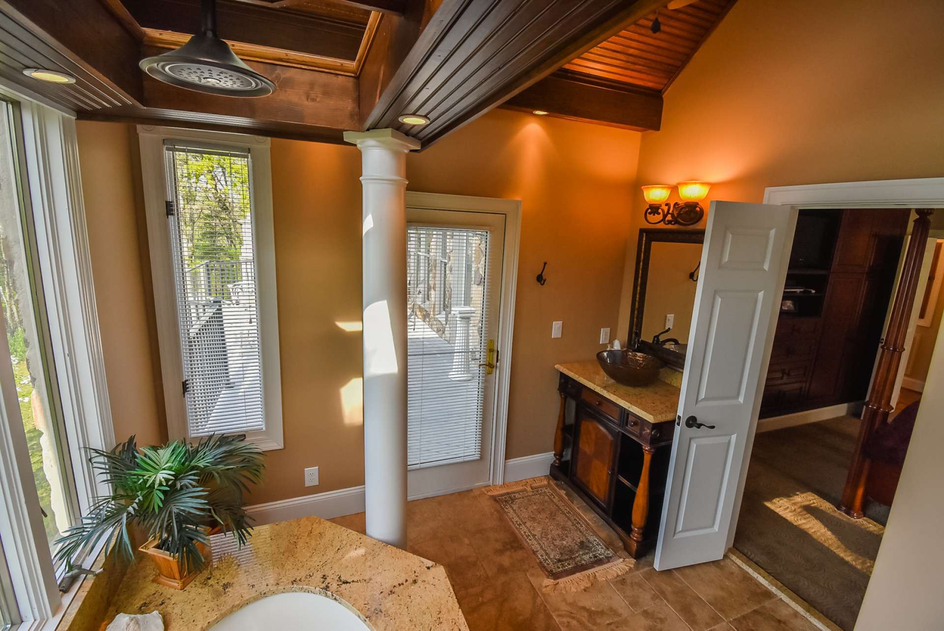 The master bath also features travertine tile floors, granite vanity top, and granite tub surround.