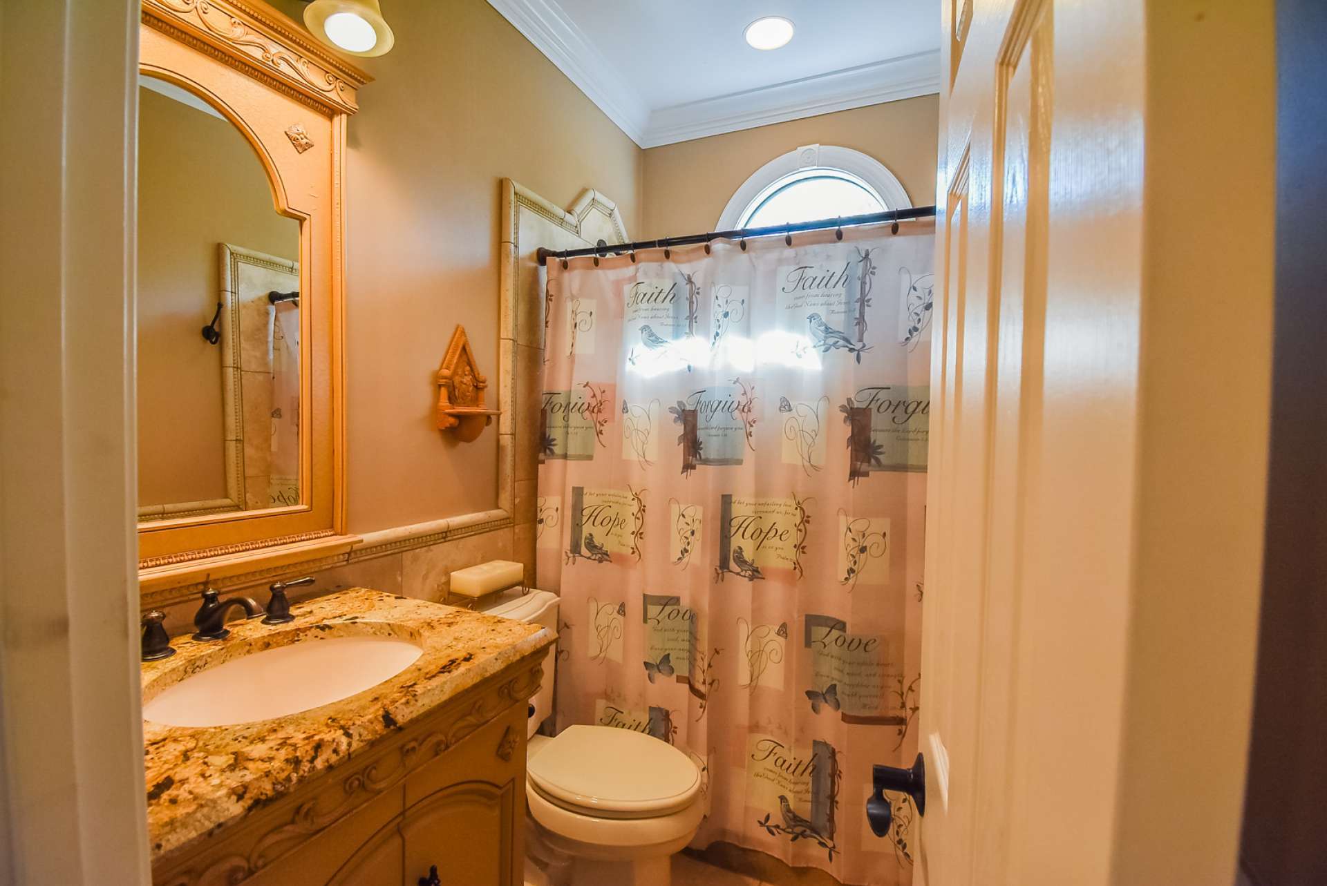 This is the main level guest bath with tile shower.