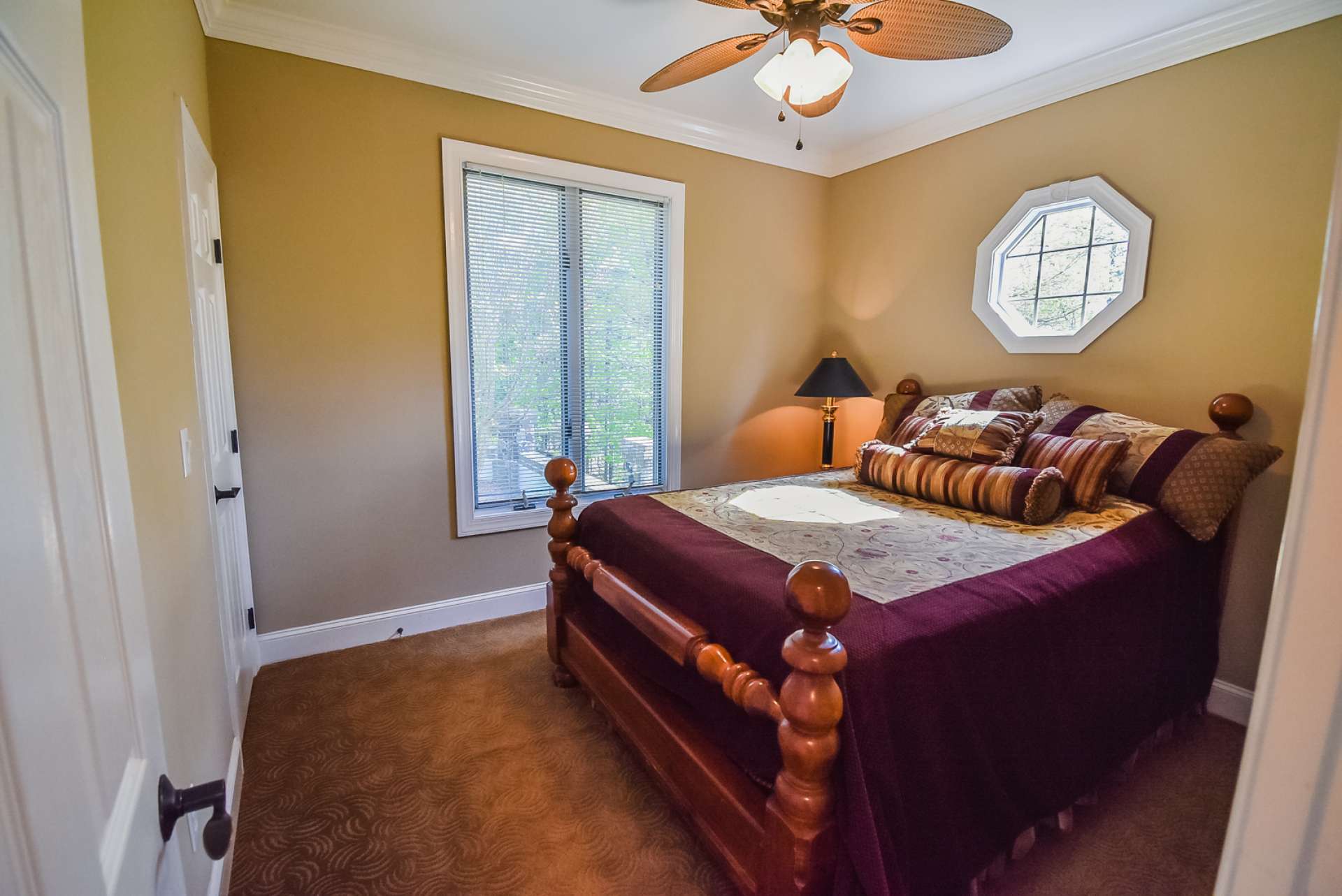 The main level guest bedroom is spacious with comfortable carpeted floor.