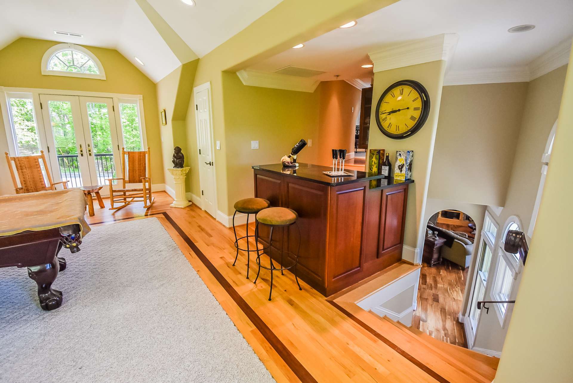 This angle shows, again, the many custom details and architectural accents. Just past the bar area, steps lead to the third level.