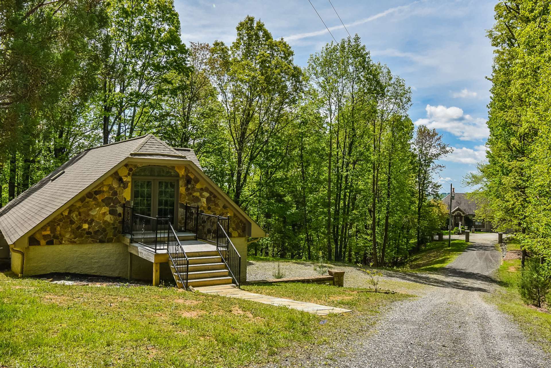 As you enter through the gate, the detached 4-car garage is on the left.