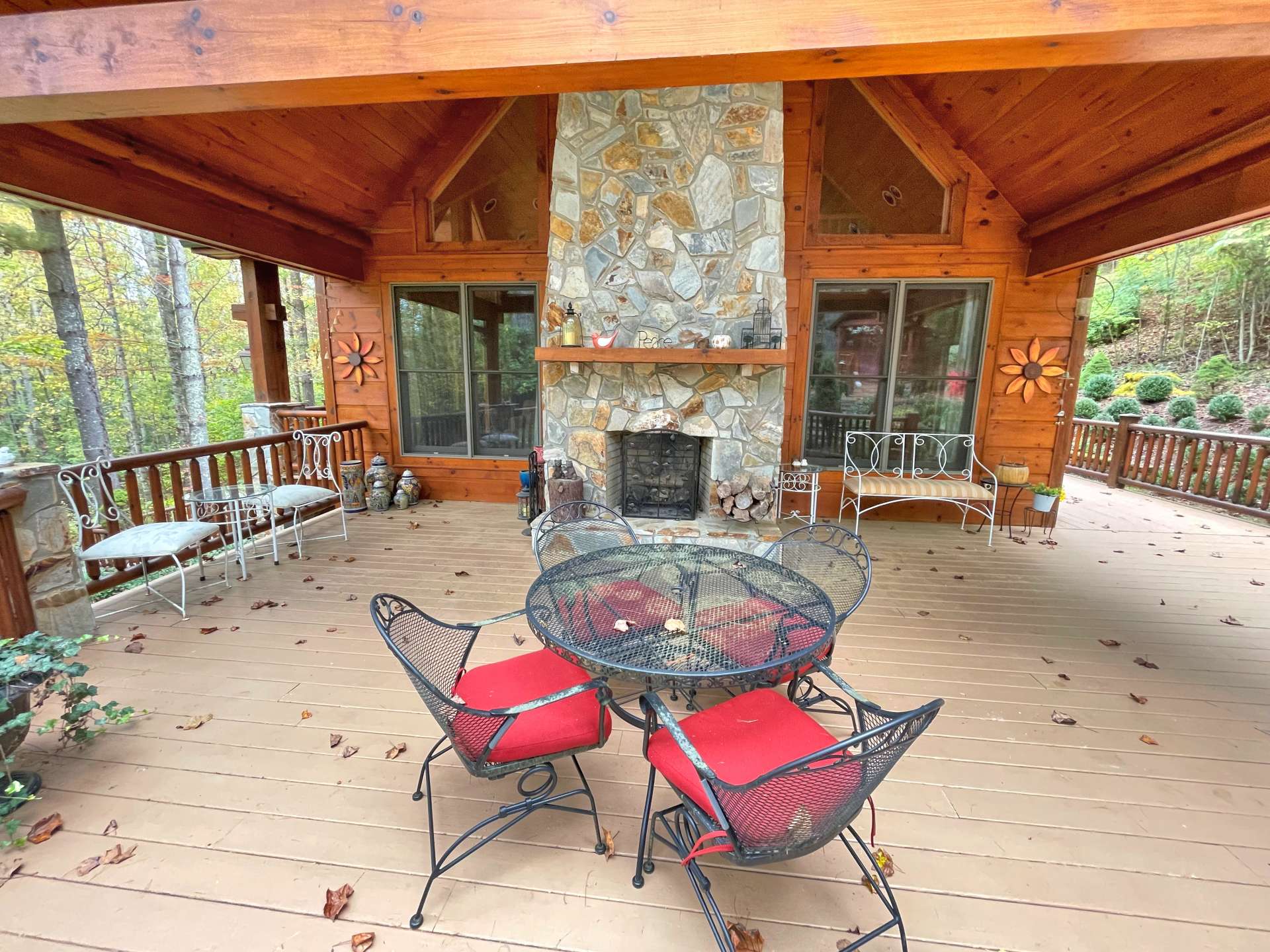 Covered Deck area with wood-burning fireplace for outdoor dining and entertaining