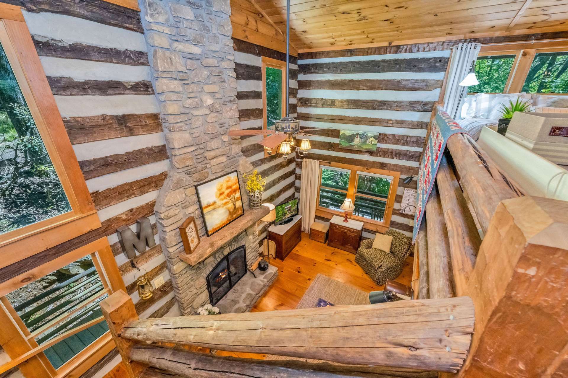 Hand-hewn stairs lead to the upper level with a loft area serving as the guest bedroom.