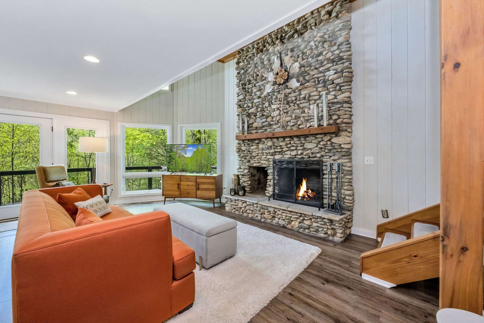 Massive stone fireplace anchors the living room.