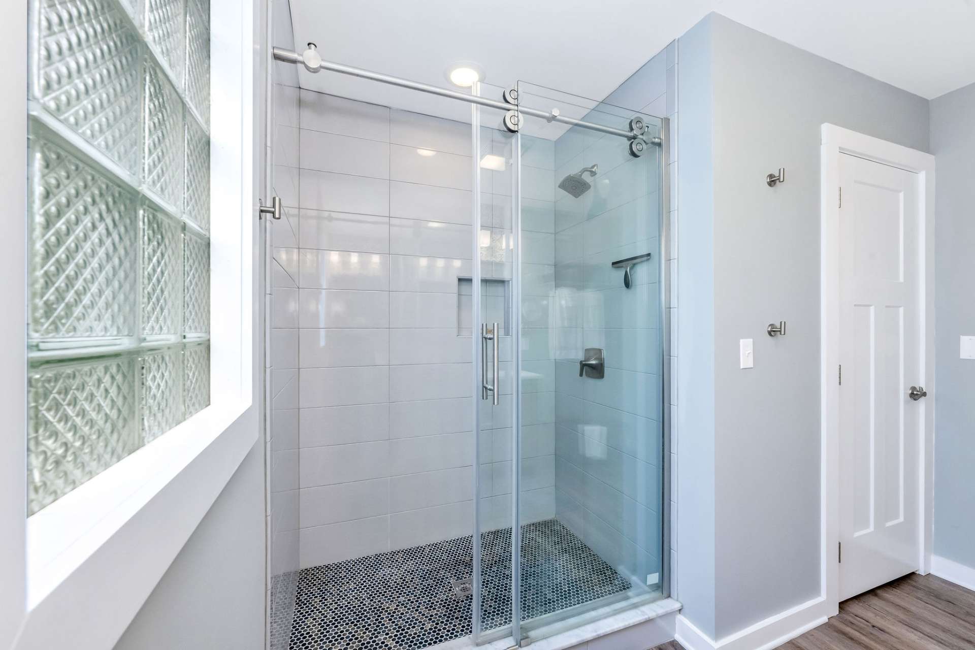 Sliding glass doors and tiled shower.