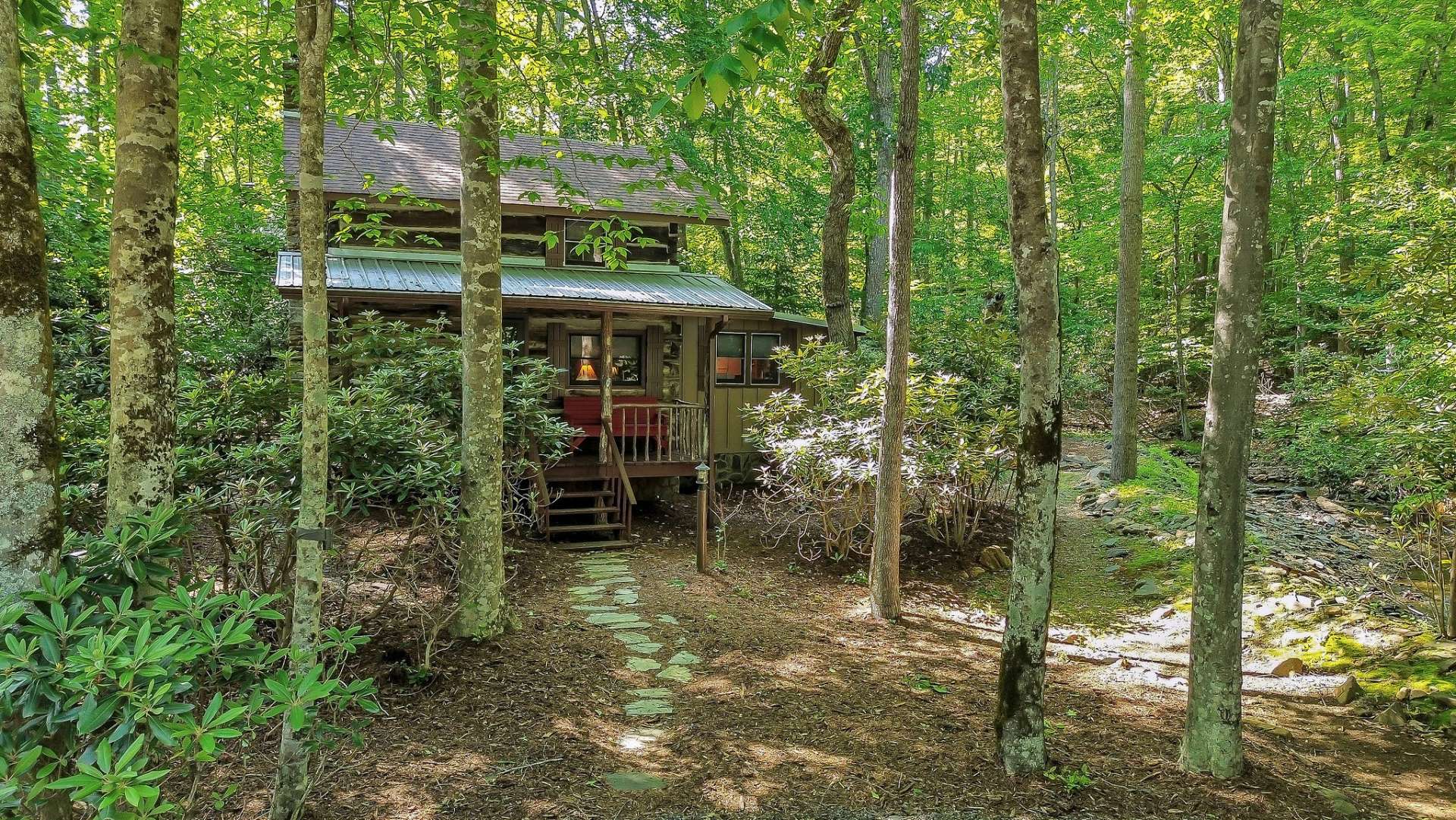 Great wooded setting by a creek. Call today for more information on our listing W134.