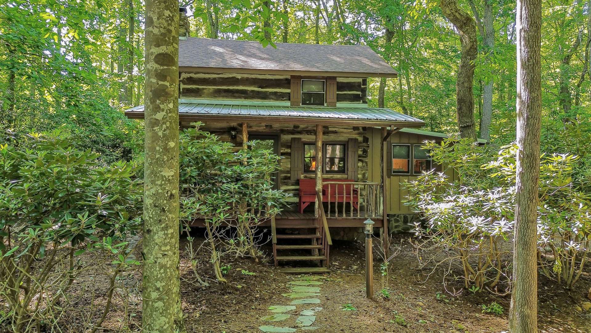 Log cabin in a wooded setting.
