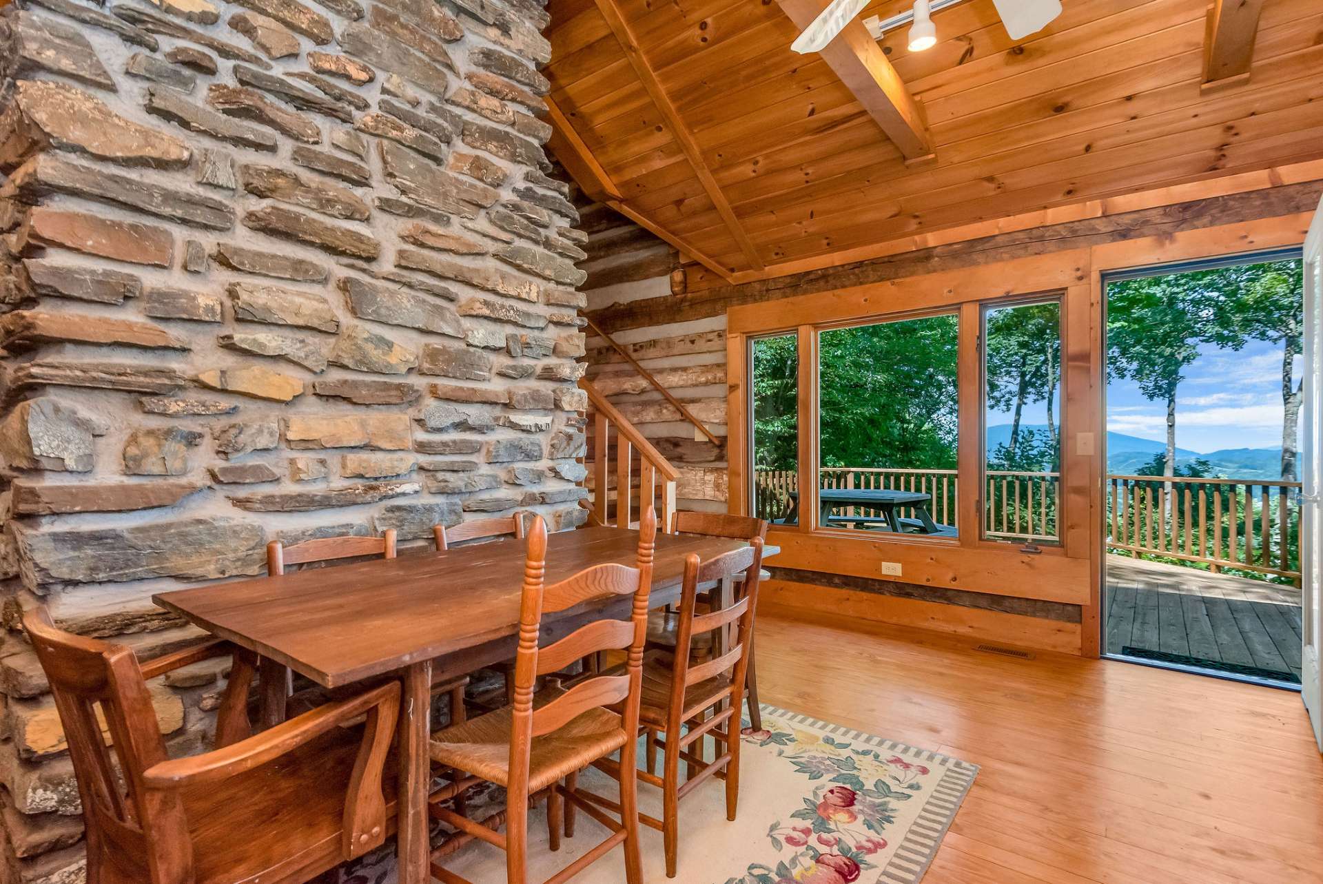 Enjoy dining with the views year-round. The cabin has multiple access points to the expansive back deck creating an easy flow for outdoor entertaining of family and friends.