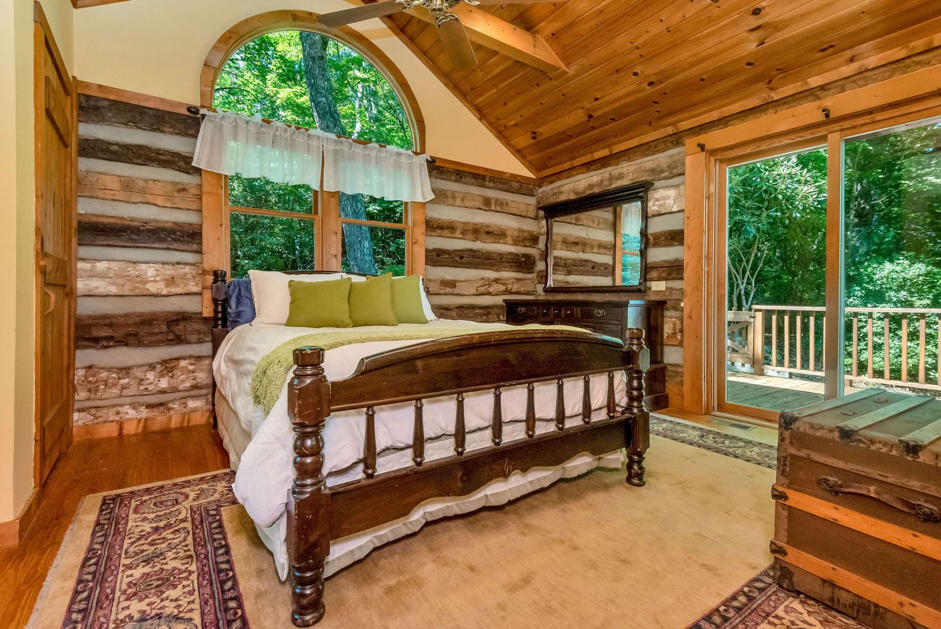 Primary bedroom on the main level with a sliding door leading to the deck.