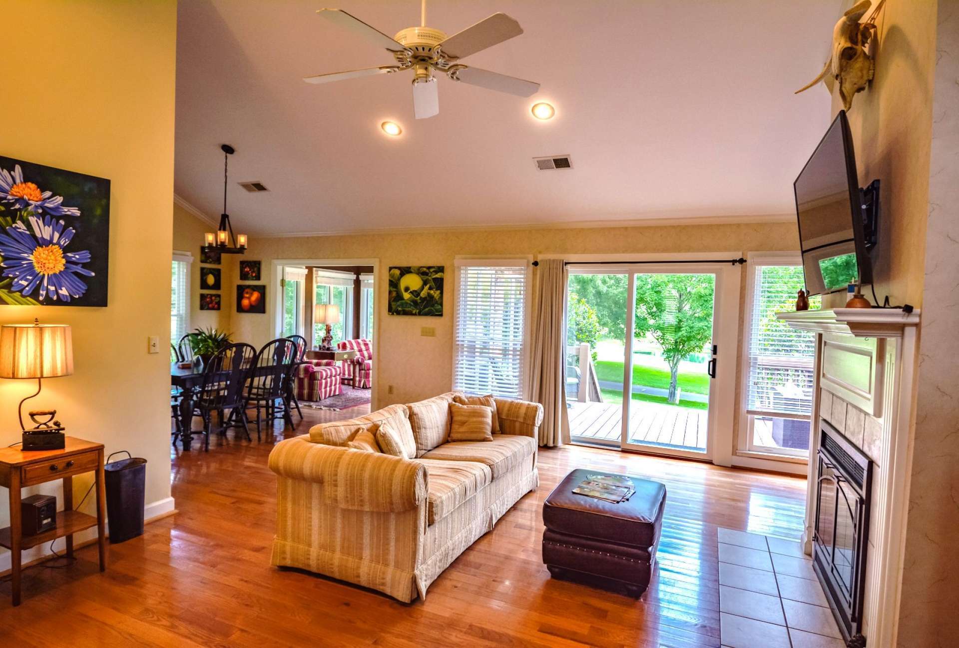 The heart-of-the-home is found in the large great room featuring vaulted ceiling, hardwood floor, gas log fireplace, and a wall of windows to capture the views and flood the room with natural light.