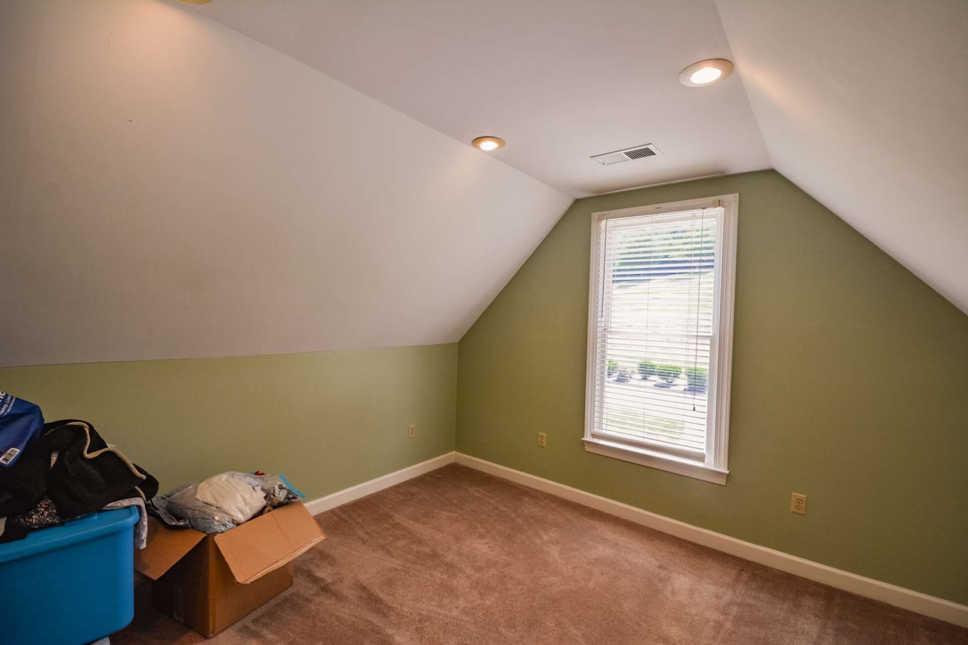 The upper level bedroom is currently utilized as storage space and could also be a home office or library.