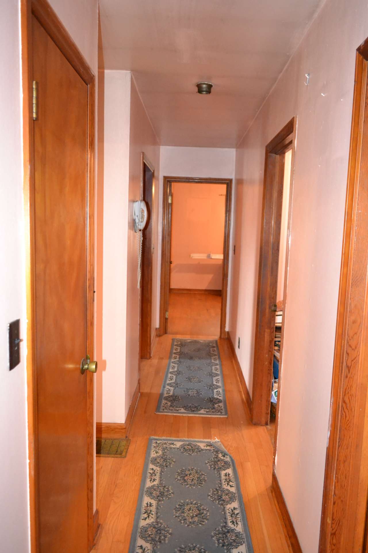 There are three bedrooms, all with hardwood floors.