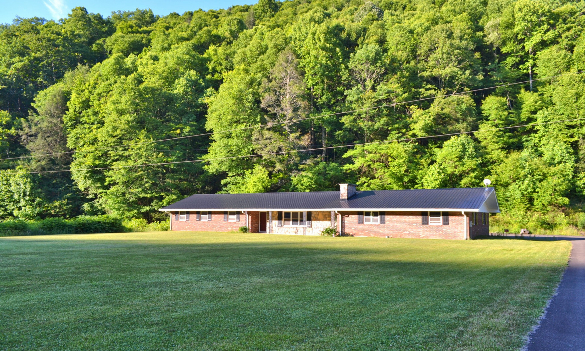 Enjoy creekfront living in this spacious ranch style home nestled on a 5+ acre setting on the banks of Big Wilson Creek in the Grayson Highlands  area of Grayson County.