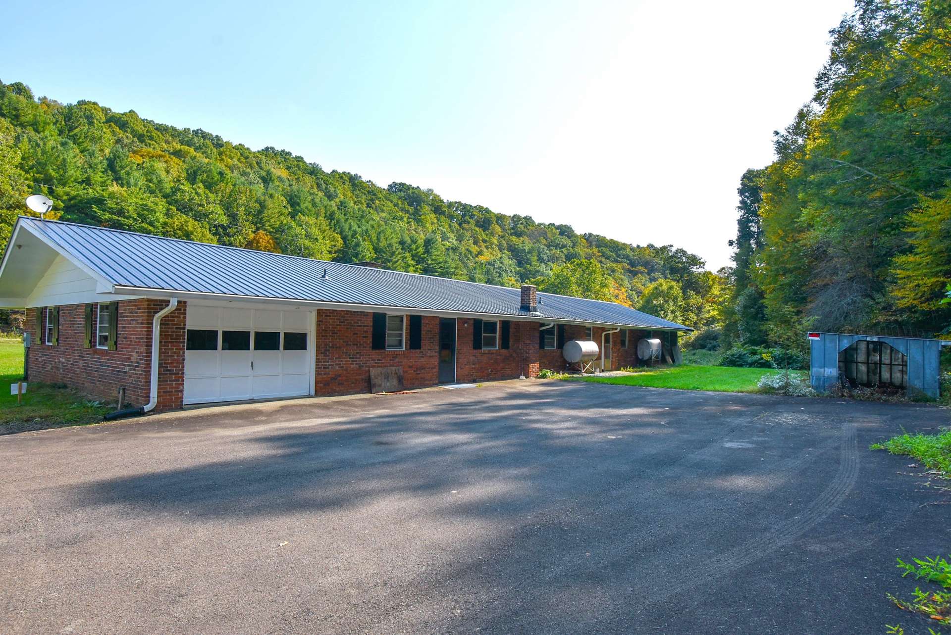 A shared paved driveway  continues on to the back of the house with garage and plenty of  parking space.