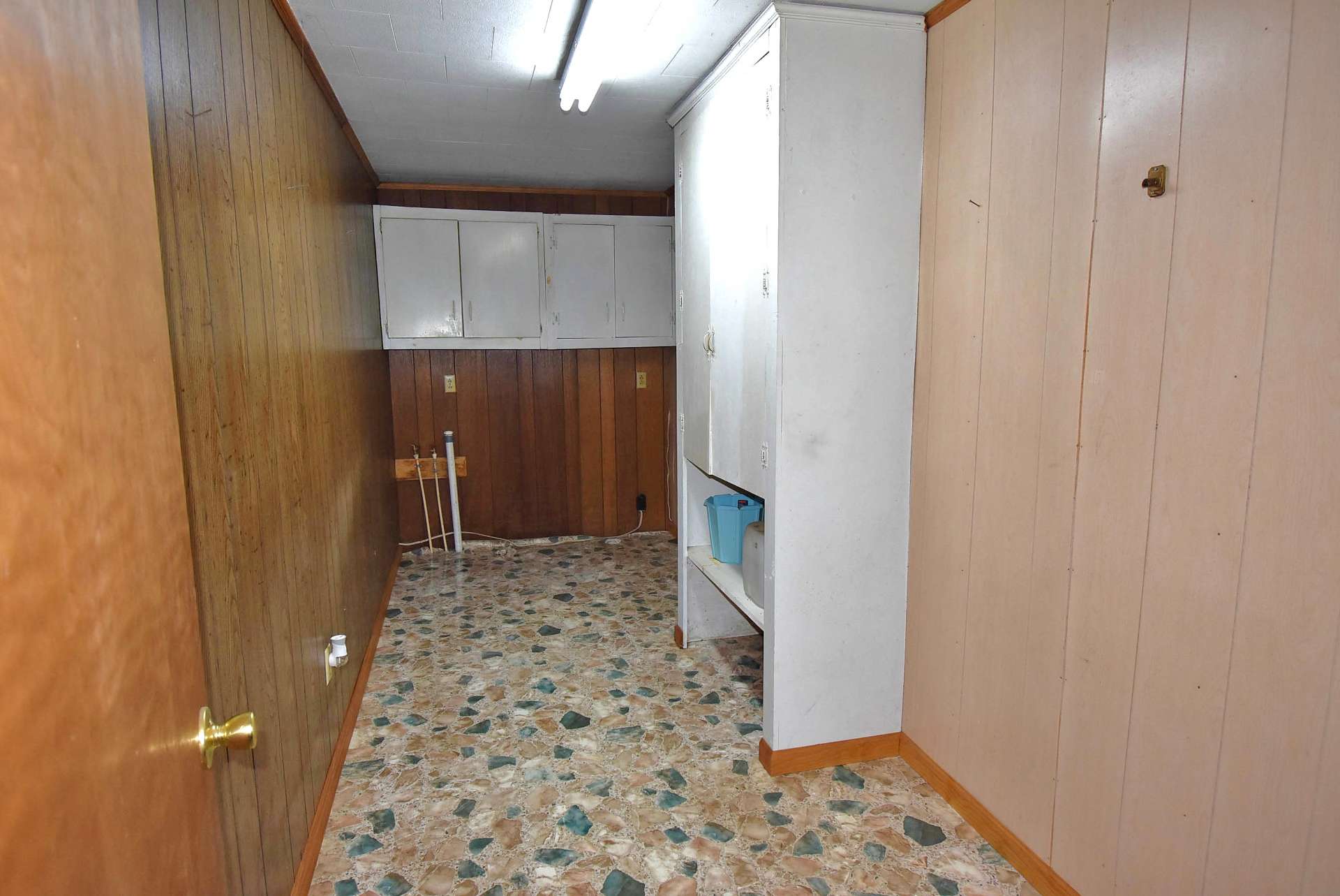 Convenient one level living that includes this  laundry room with extra storage space.