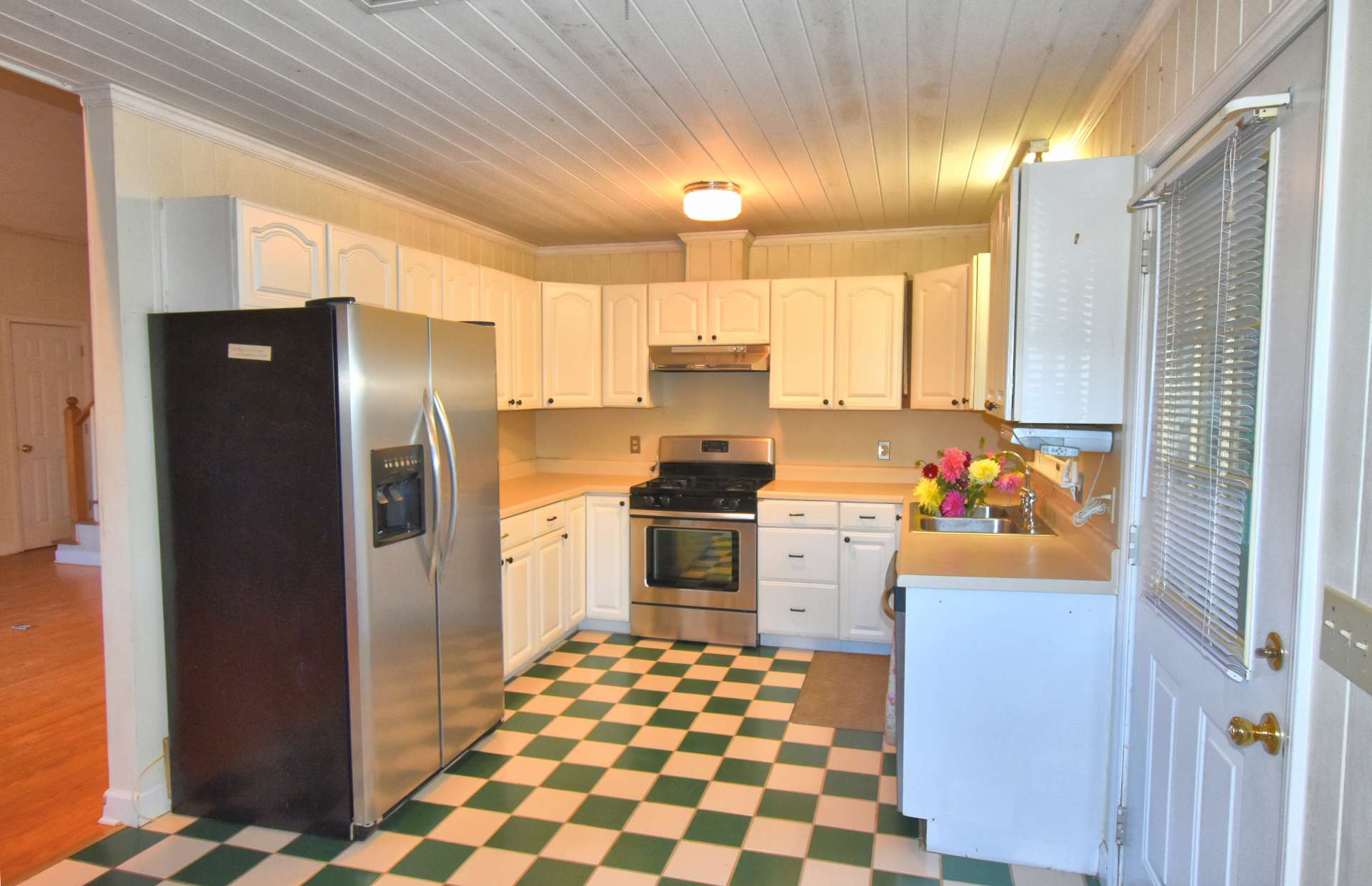 The efficient farm style kitchen offers ample work and storage space along stainless appliances that includes a gas range.