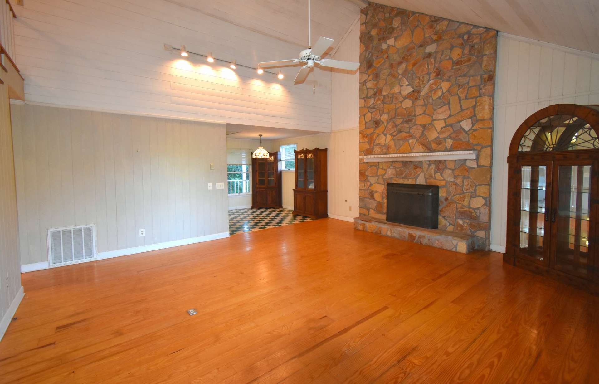 You will love the oven living area with high partially vaulted ceiling, stone wood-burning fireplace and wood floors.