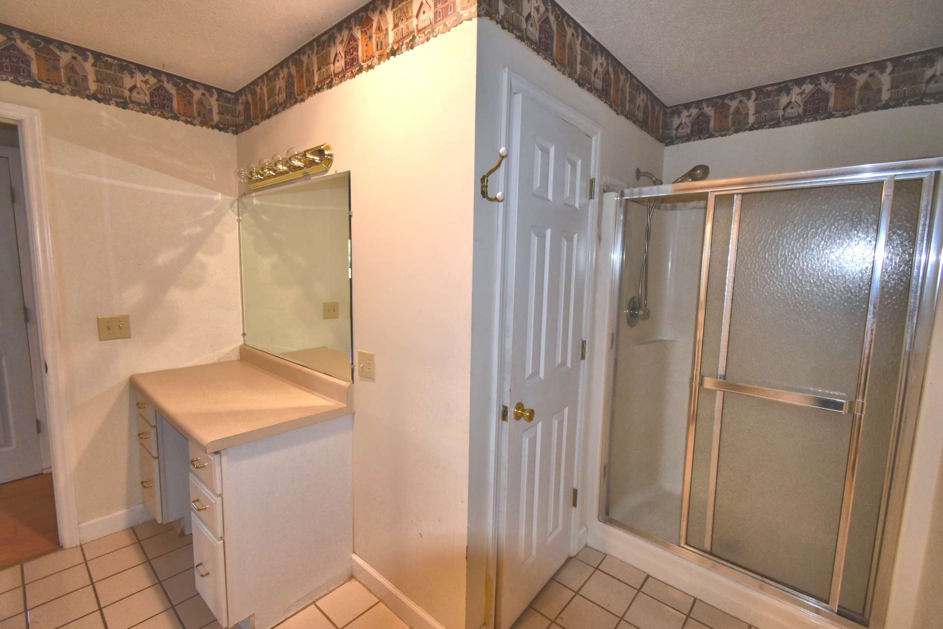 The main level bath features a walk-in shower and a make-up vanity.