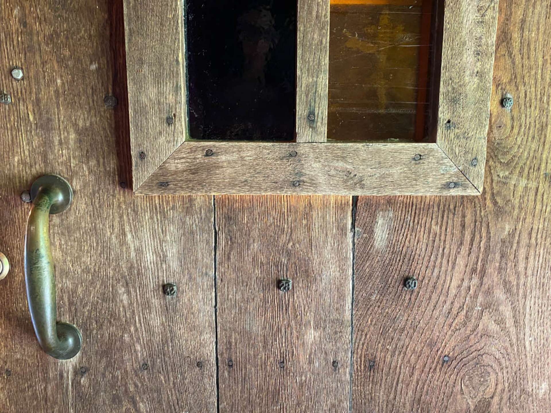 Front door accented with nails from the Virginia Creeper Railroad and early 1800s stained glass.