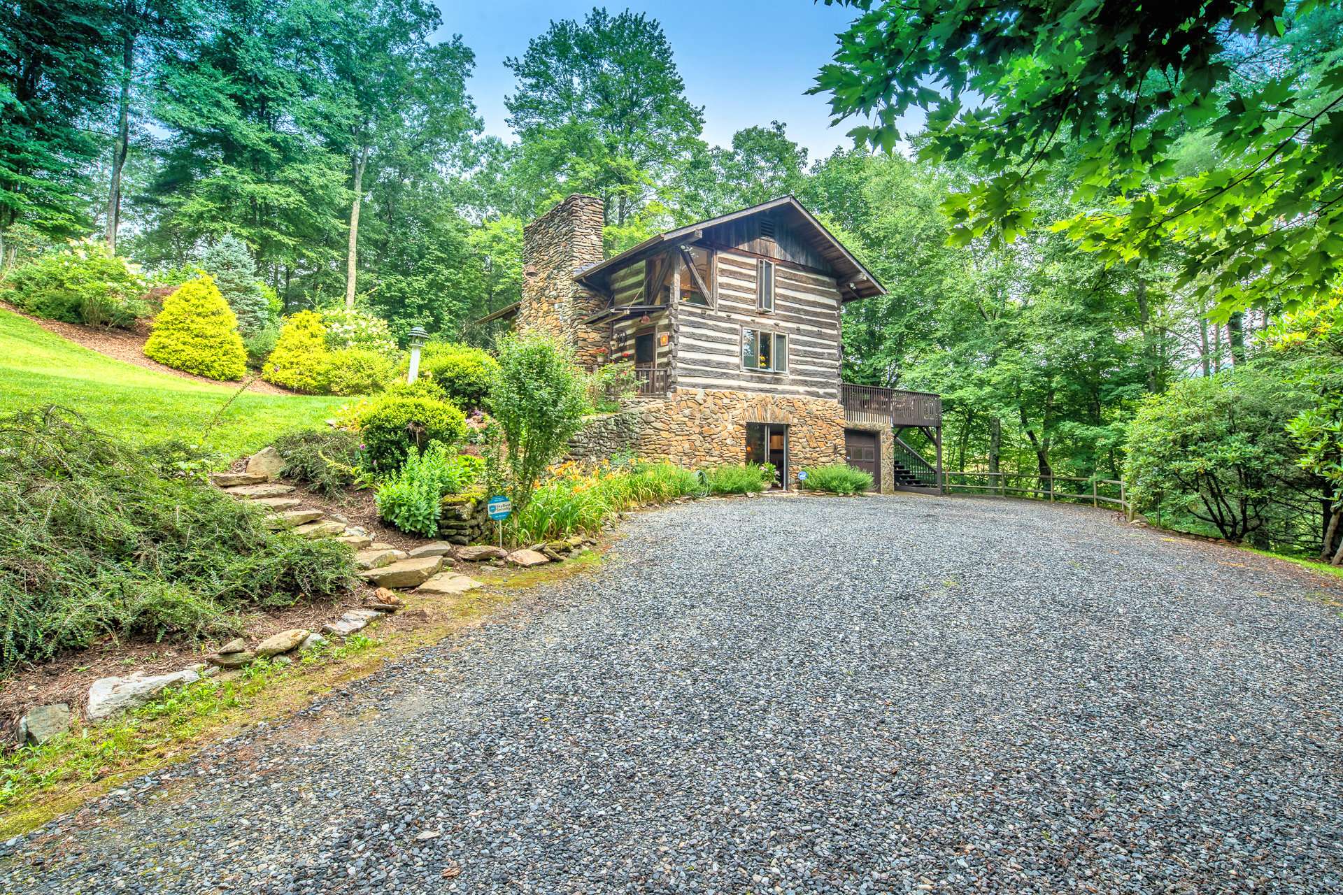 Journey up the driveway by lush rhododendron and gorgeous trees to find the cabin waiting for you to enjoy mountain living on a private 7.8 acre setting just minutes to downtown West Jefferson.