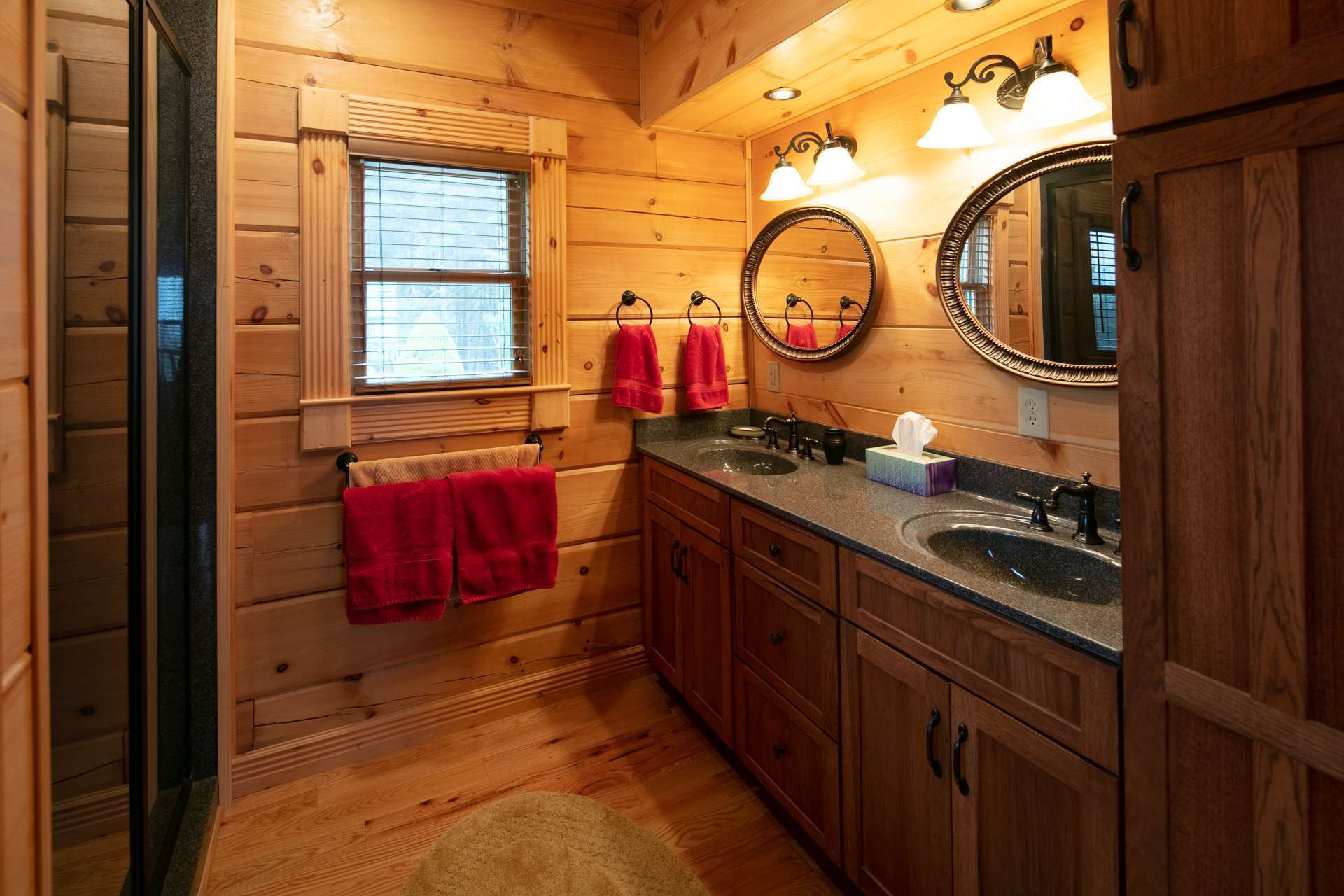 The master bath features double vanities and walk-in shower. A half bath completes the main level of the home.
