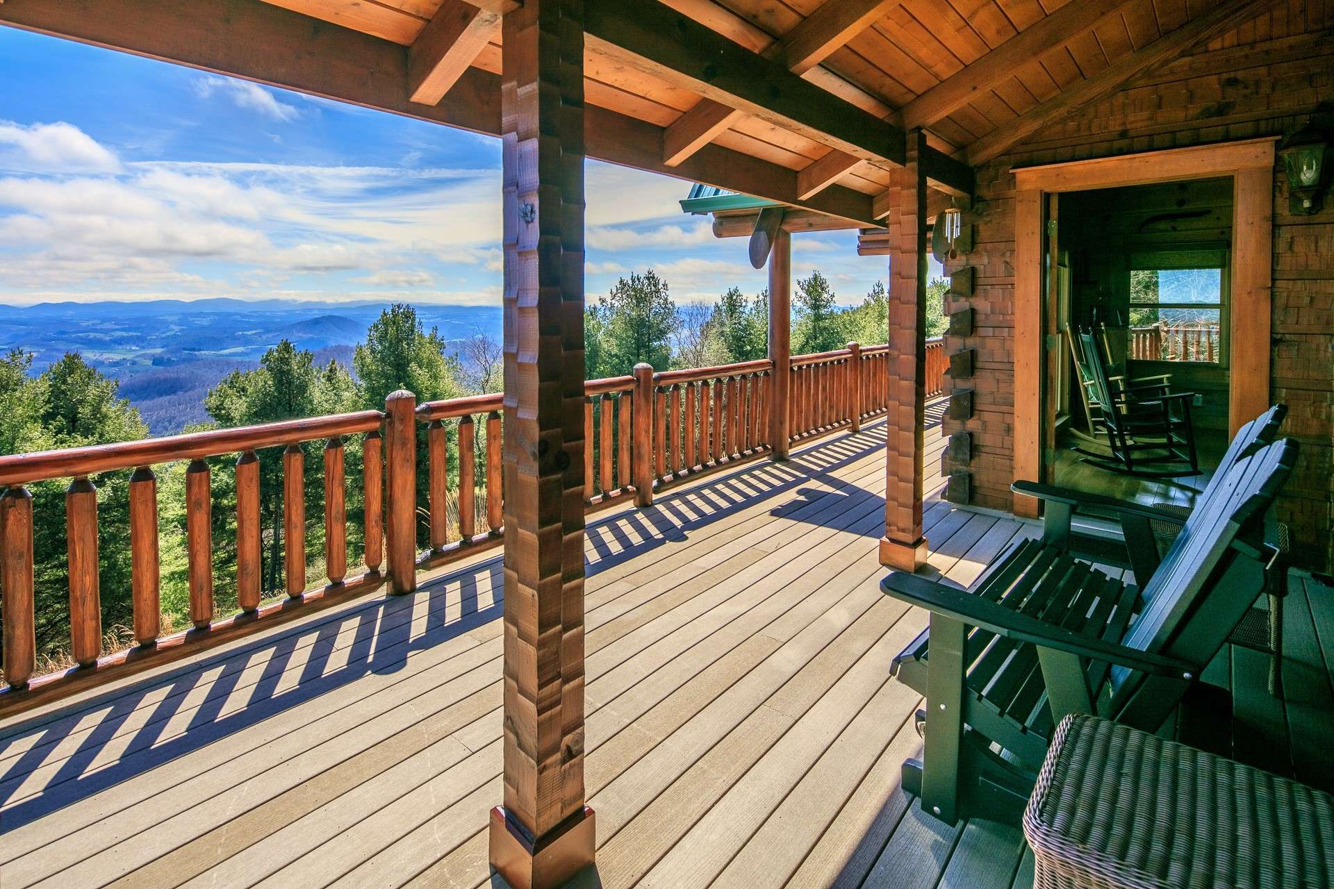 The main level opens to a partially covered wrap around deck to enjoy outdoor grilling, dining, and entertaining while enjoying breathtaking panoramic long range views.