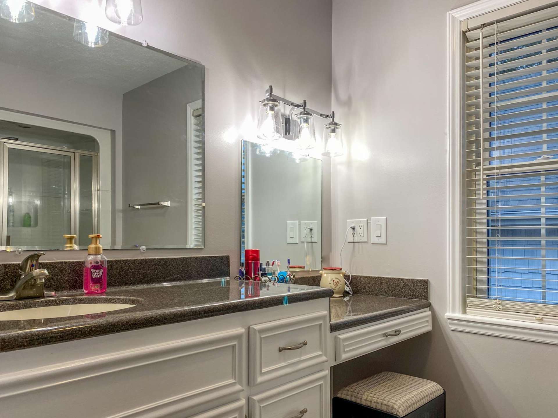 This is "Her" bathroom with 48" shower, fresh paint, new lighting, and ceramic tile floor.