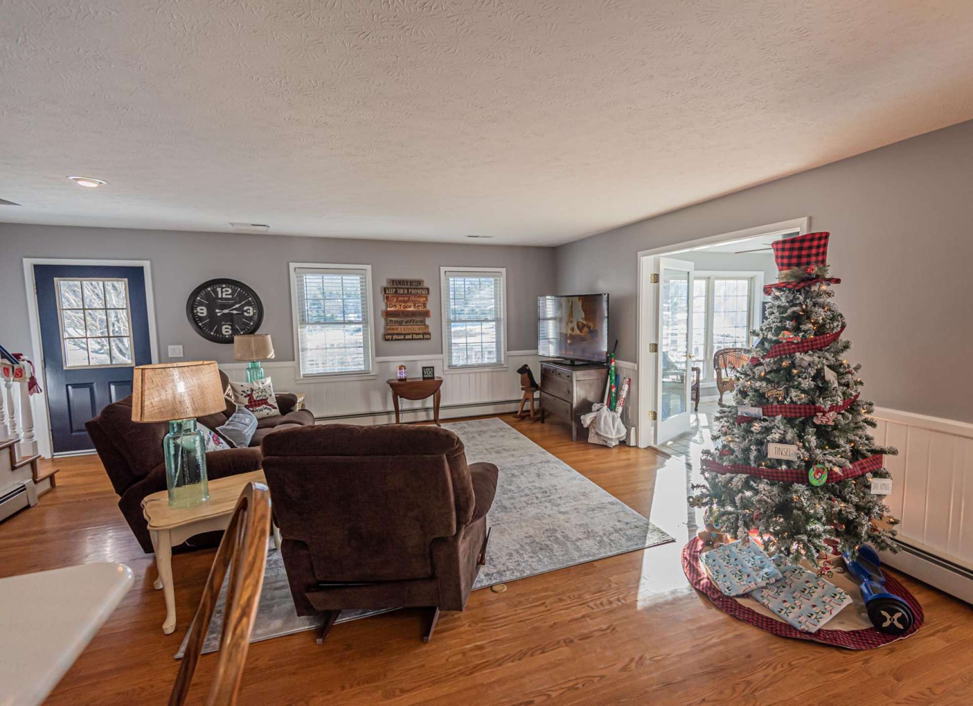 The open floor plan includes the living area open to the kitchen and dining areas.  The great room features lots of windows for natural light and beautiful hardwood floors.