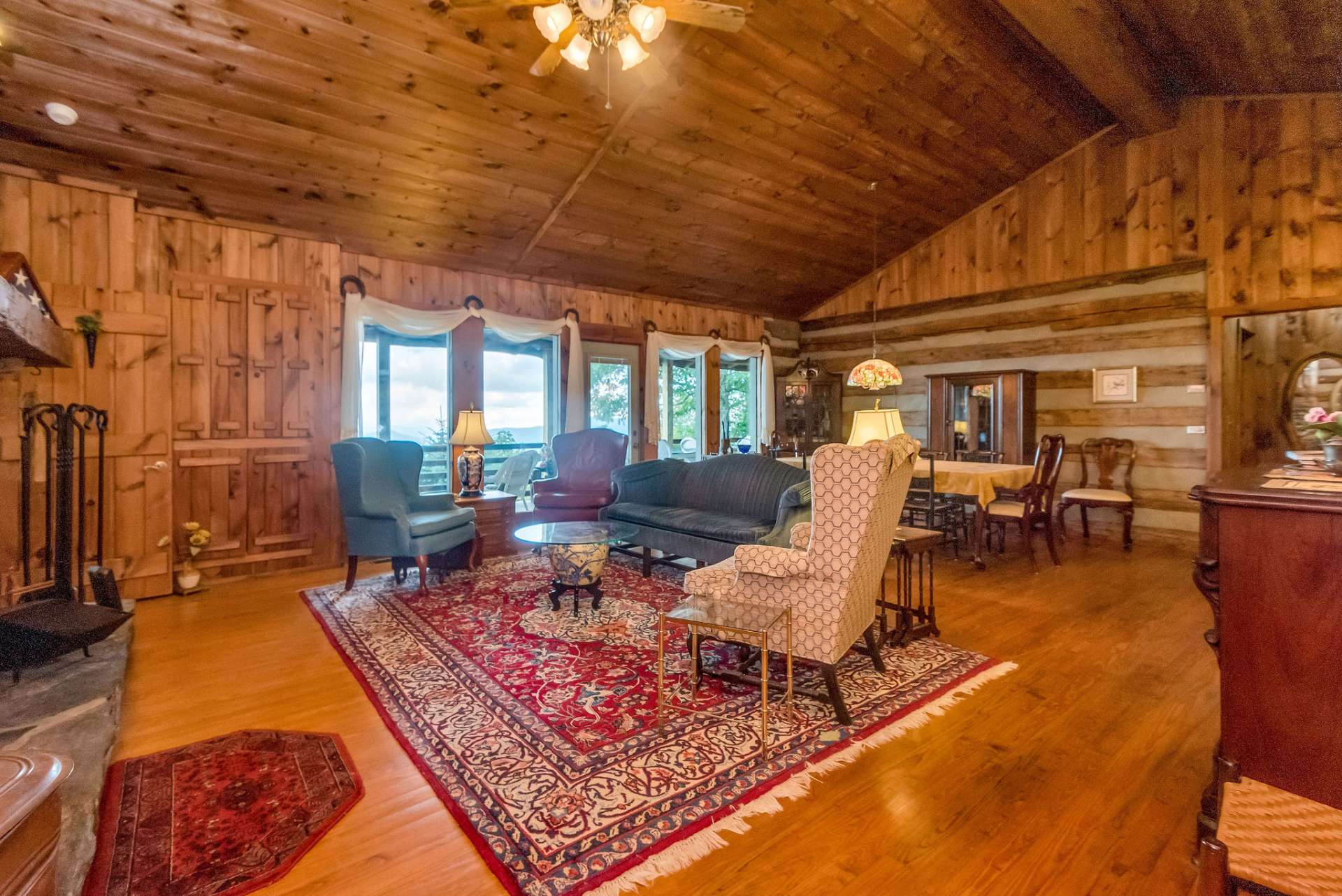 The truly great room offers vaulted ceilings to let the natural light radiate into the room and set the warm wood colors aglow.