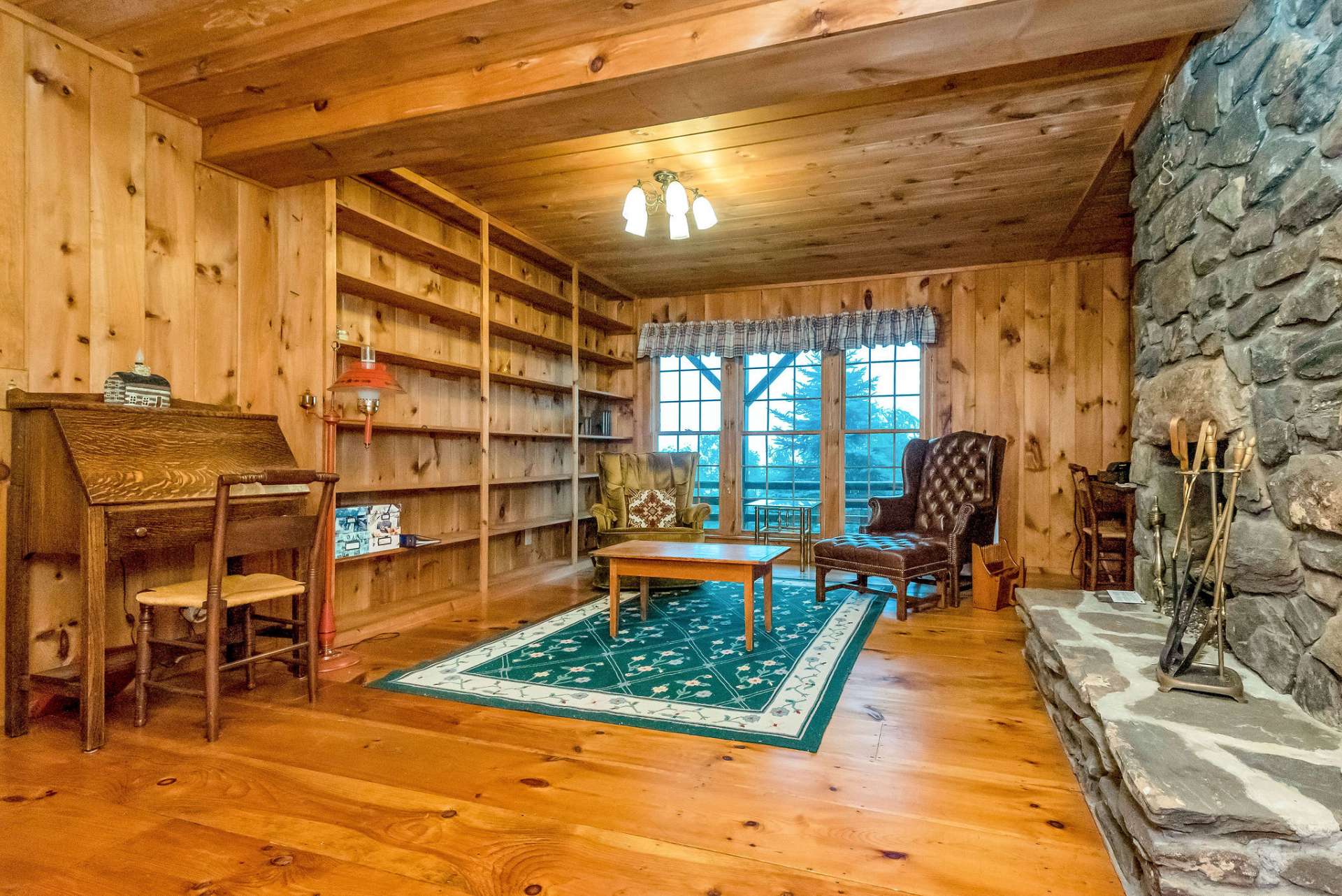 A stairway leads you to the lower level where you will enter the charming rustic library.