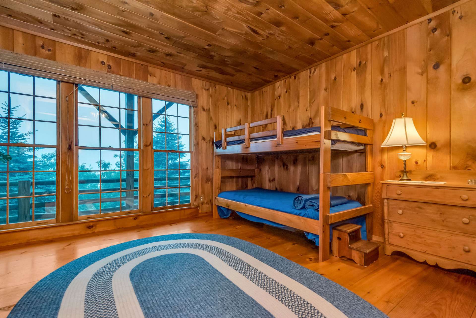 This room is currently called the bunk room where the grandkids can feel like they're camping in the great outdoors with the floor to ceiling windows.