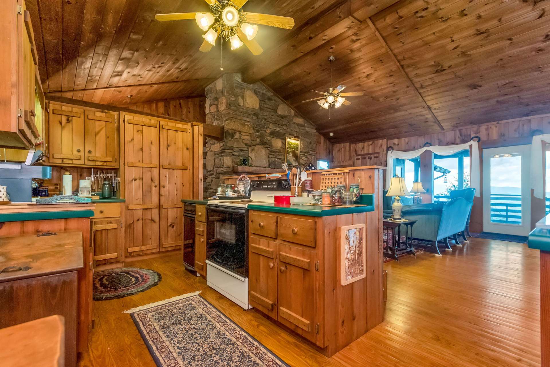 The kitchen features an abundance of custom built cabinets and a pantry.