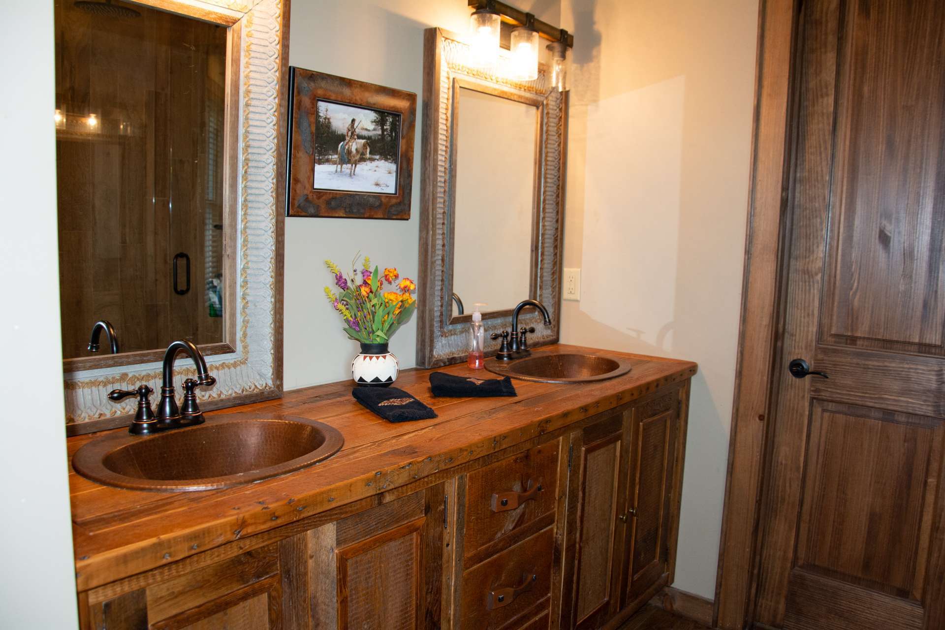 The master bath offers a double vanity with the hammered copper sinks, exposed beams and a separate tiled shower. A powder room and laundry room completes the main level.