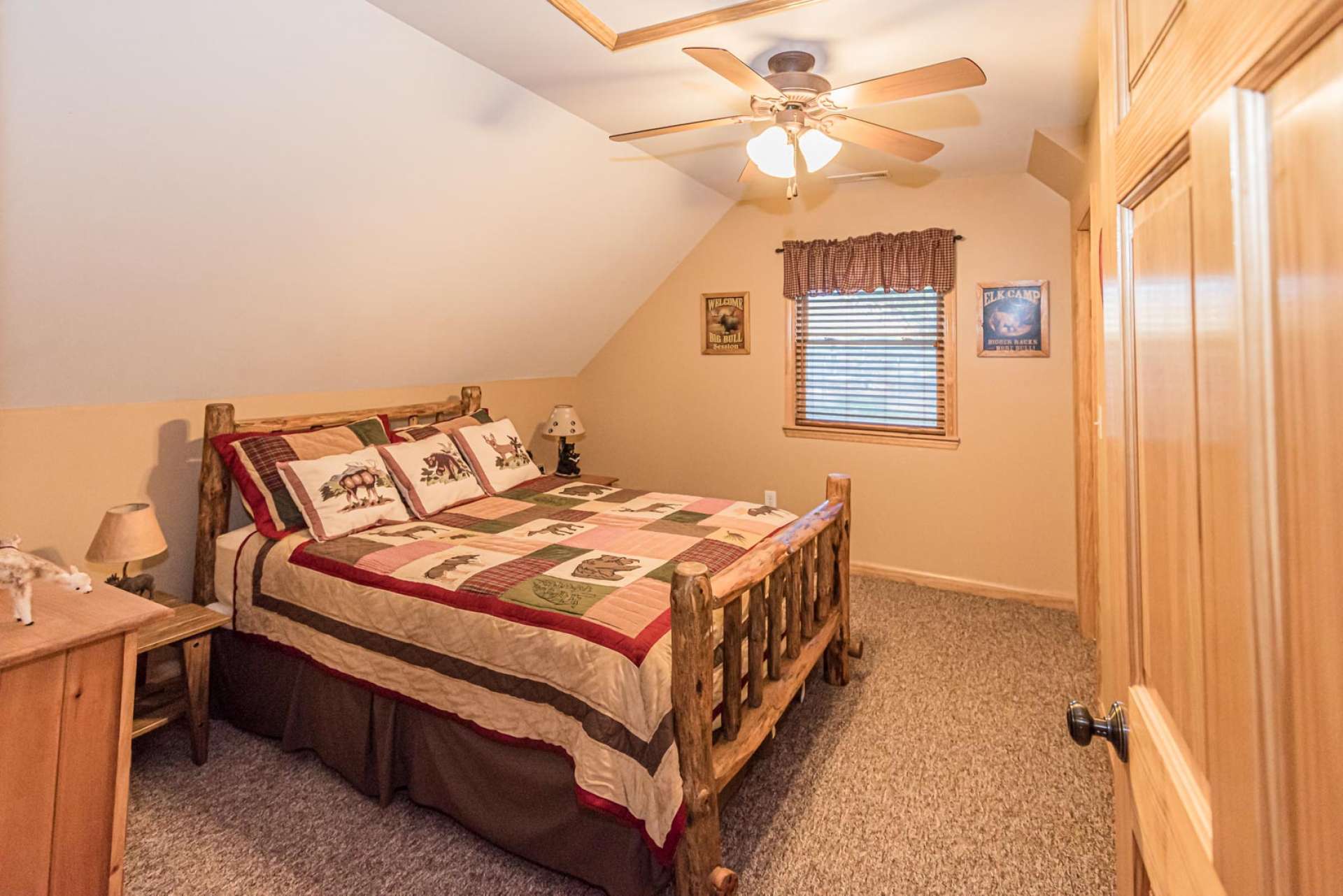 The upper level guest bedroom is cozy and inviting.