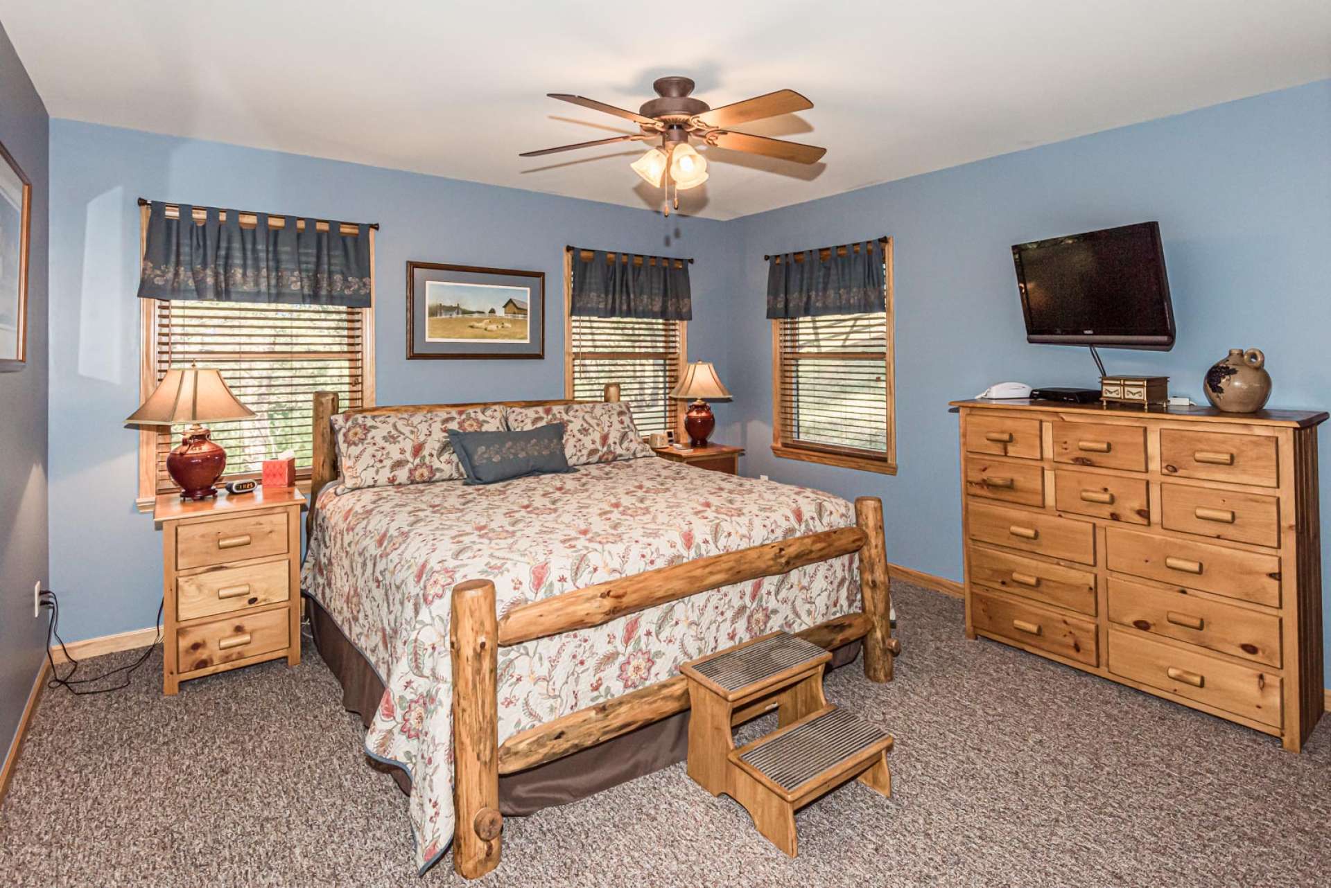 The master bedroom is conveniently located on the main level and offers a comfortable carpeted floor and plenty of windows filling the room with light.