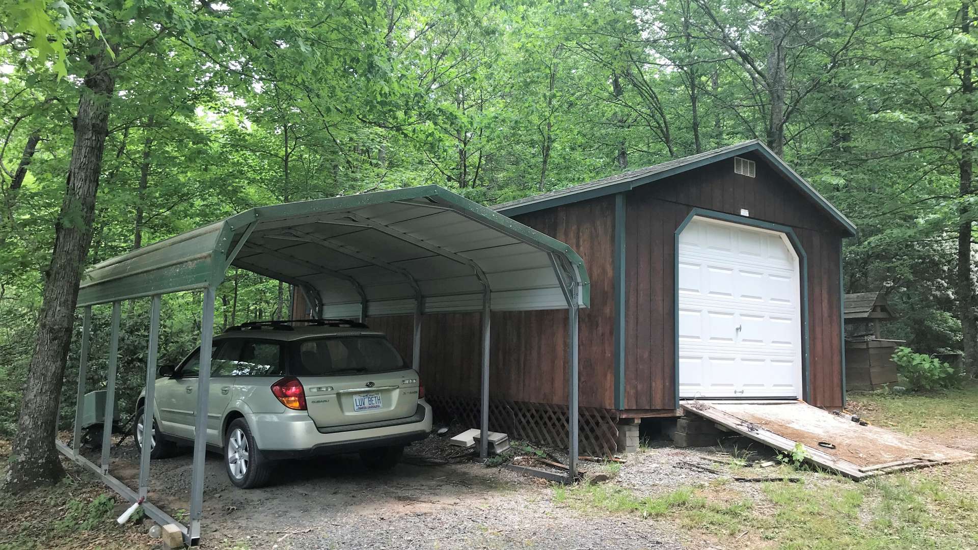 In addition to the 2-car  detached garage, there is another large outbuilding that is perfect  for a workshop or storage space.