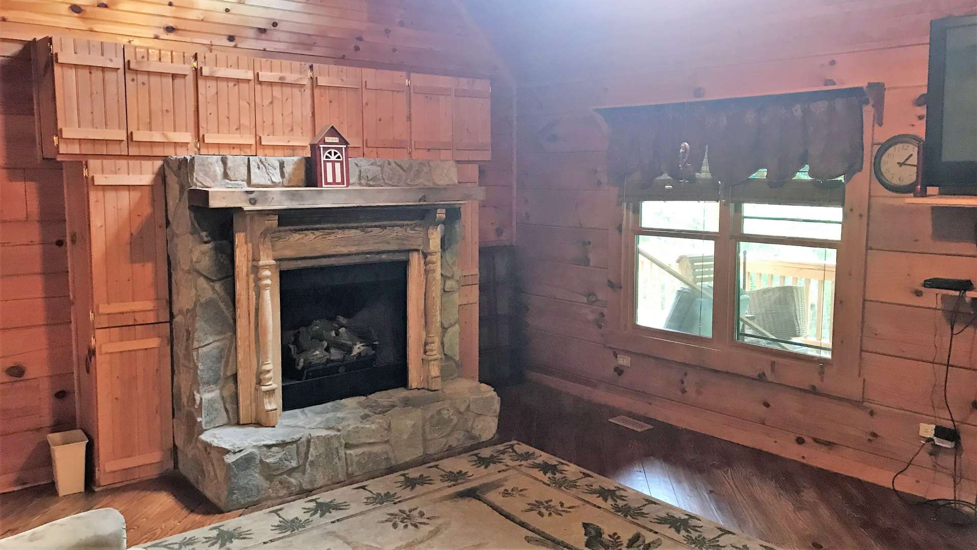 A fireplace with gas logs in the great room enhances the cabin feel and provides added warmth on cold winter evenings. Notice the built-in cabinetry flanking the fireplace.