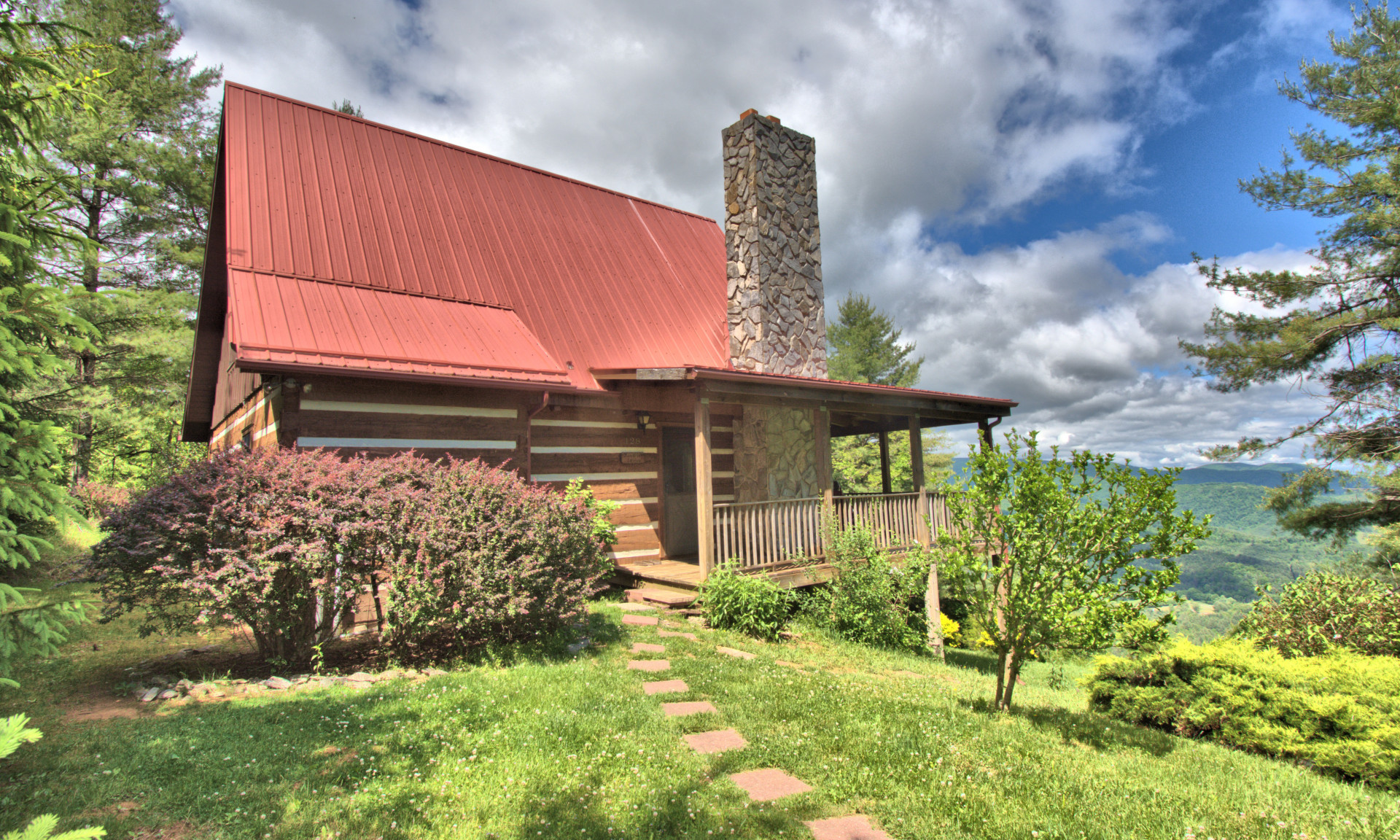 High on Kindrick Mountain, a private gated community in the Mouth of Wilson area of Grayson County in the Virginia Mountains, this charming 2-bedroom, 2-bath log cabin overlooks layers of mountain vista views and enjoys privacy of a 13.27 acre setting.