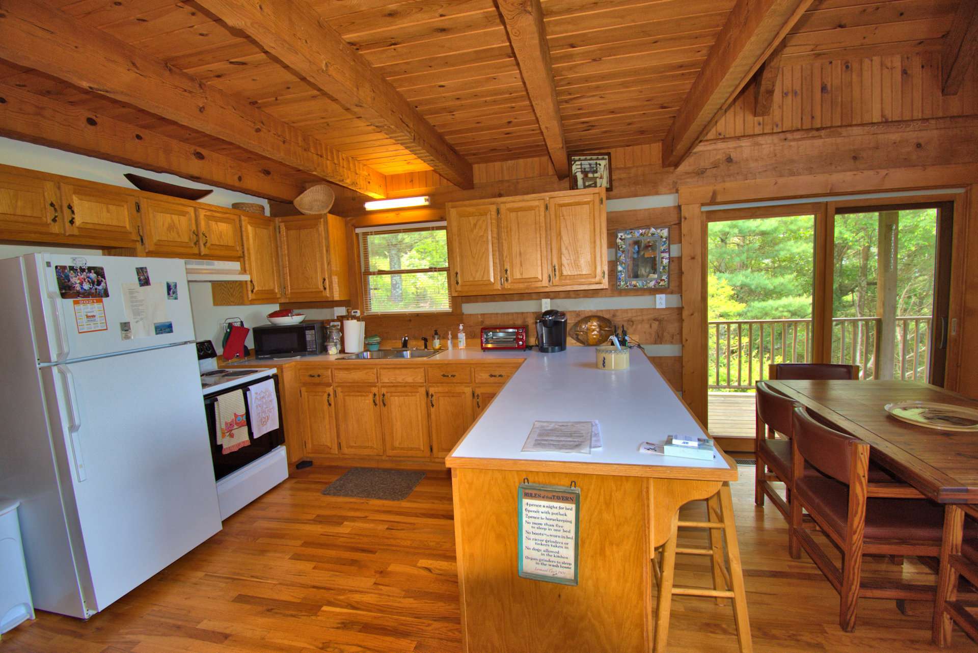 The kitchen is amply sized and features exposed beams and a bar with seating for those quick meals on the go in the mountains.