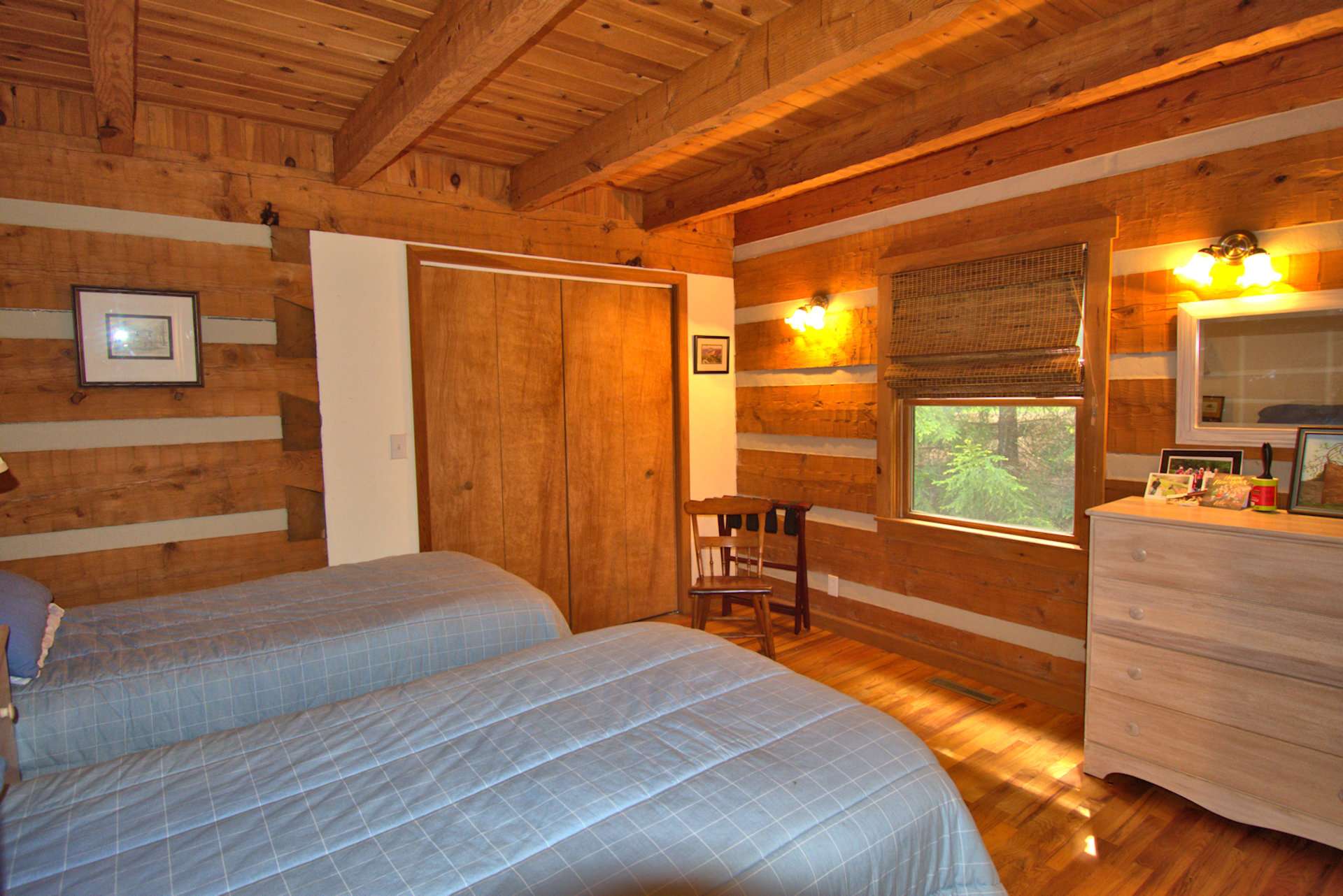 The main level bedroom is spacious with exposed beams.