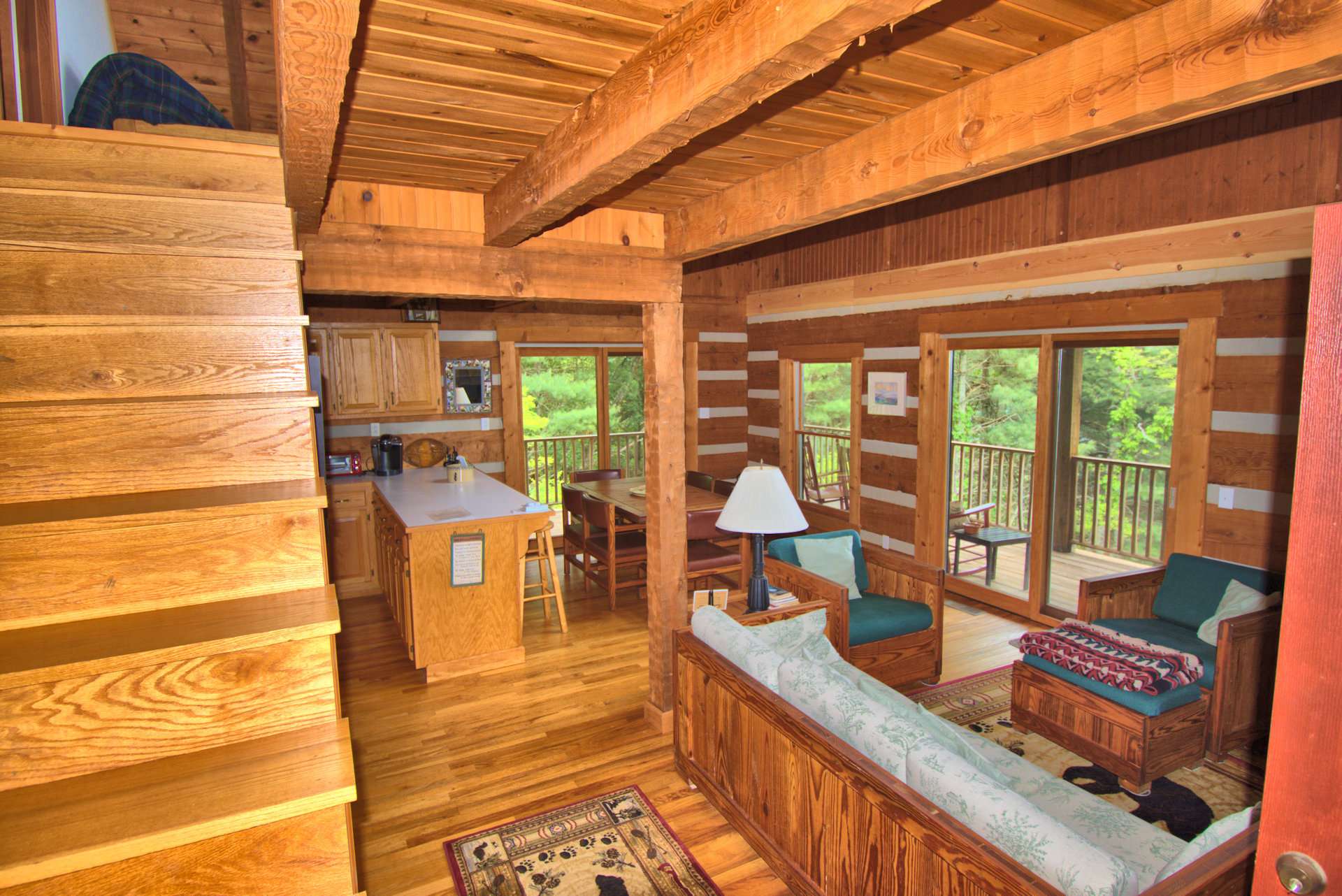 This cozy log cabin features an open great room with vaulted ceiling and plenty of windows filling the cabin with light.