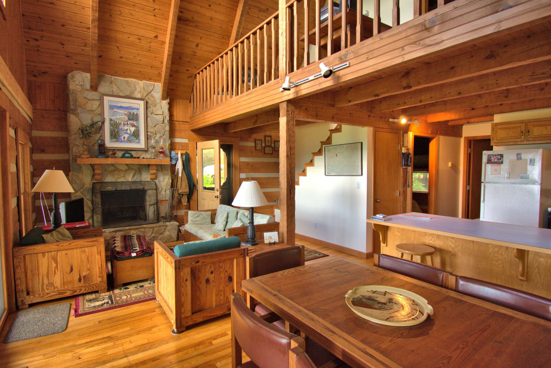 A stone wood-burning fireplace is the focal point of the living area and enhances the cabin feel.