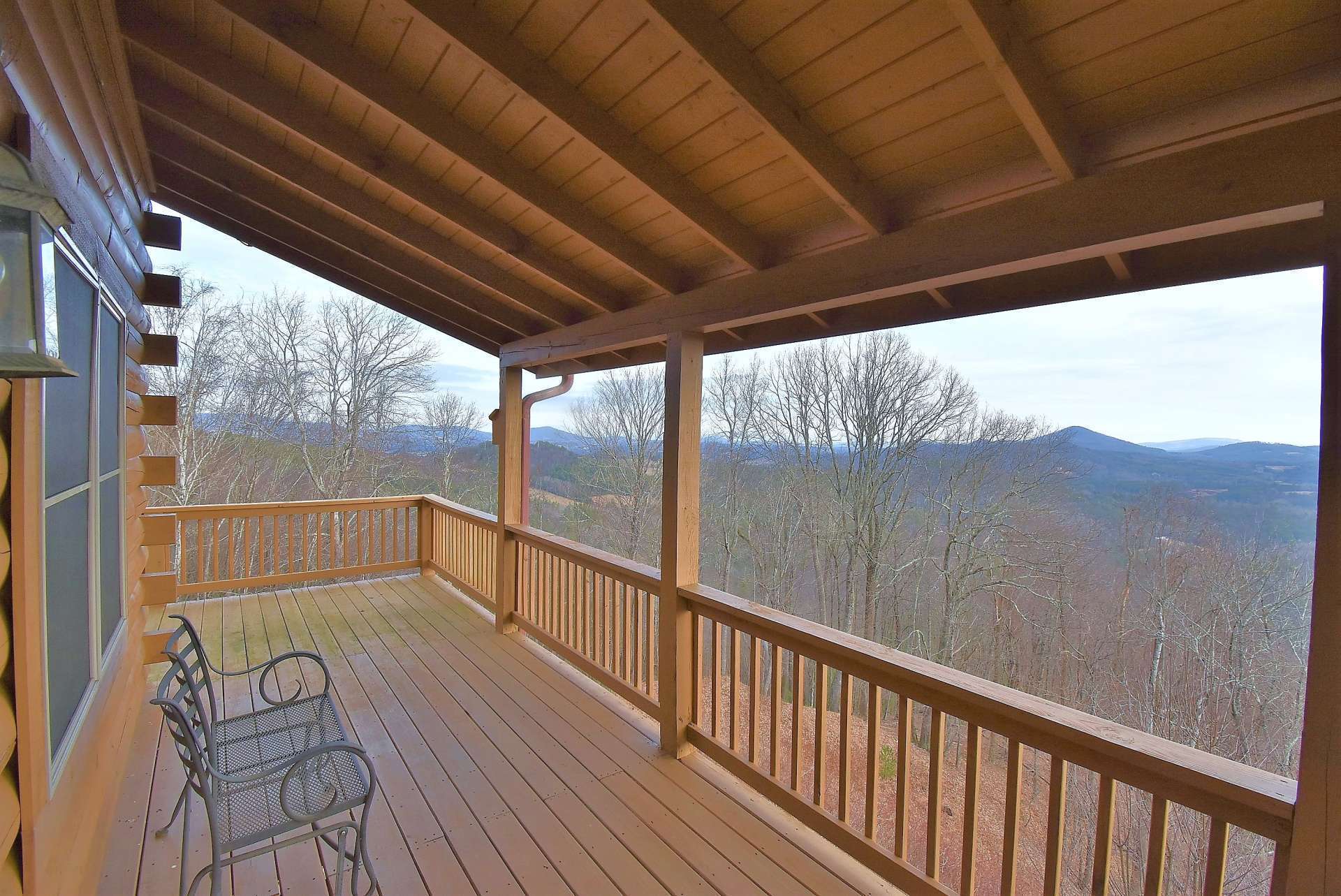 A partially covered wrap around deck provides a relaxing place to enjoy layered long range views and a front seat to Nature's symphony and changing colors.
