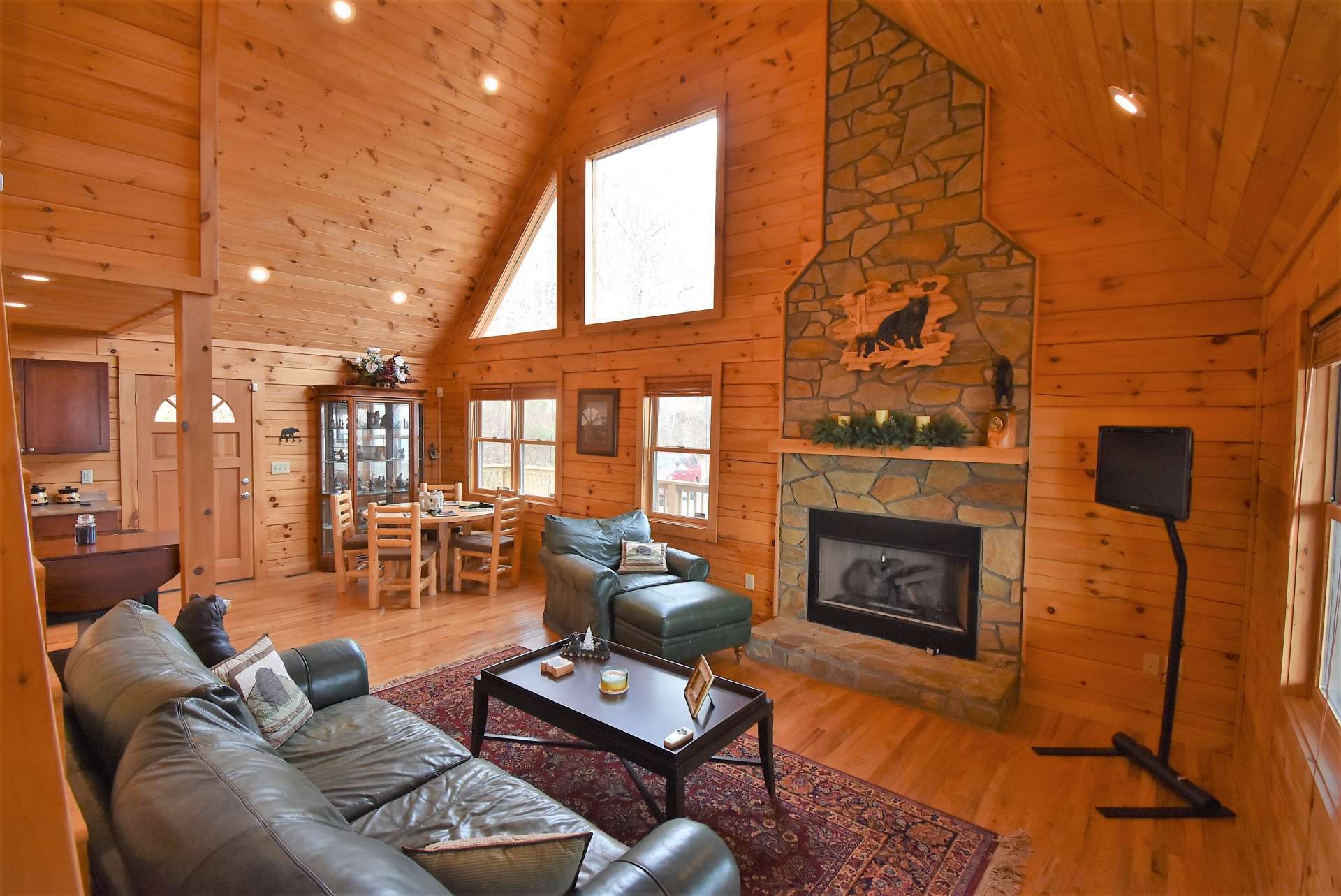 The floor to ceiling stone fireplace with gas logs is the focal point of the vaulted great room with abundant windows for natural light.