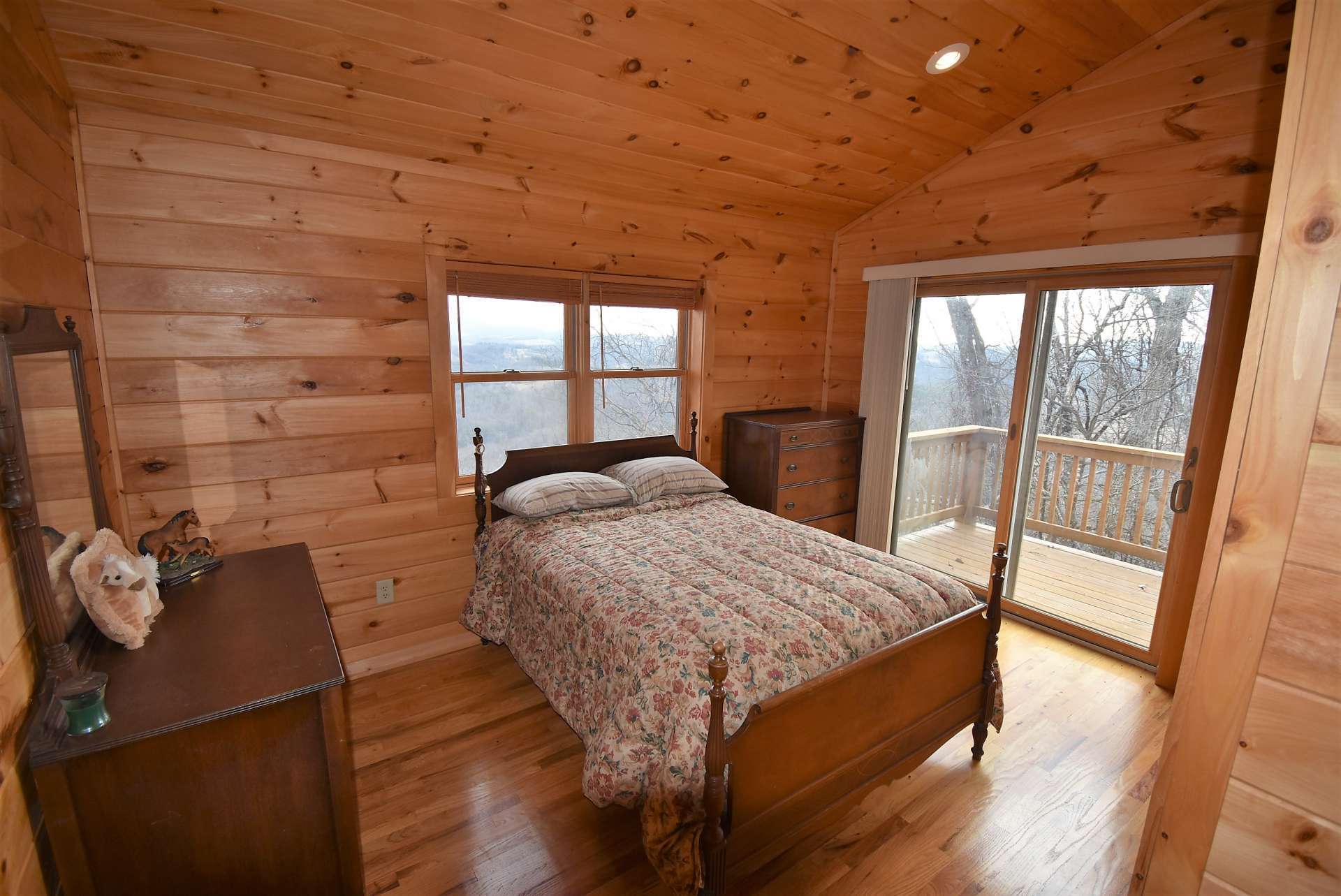This upper level bedroom features access to a private upper level balcony to enjoy the views.