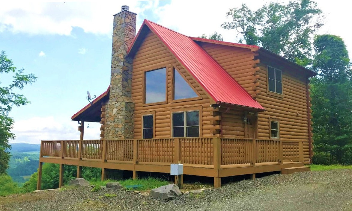 Enjoy incredible long range mountain views and amazing sunrises from this sweet 3-bedroom, 2-bath log cabin nestled on a 2 acre setting off of Round Knob Ridge Road in West Jefferson, NC.