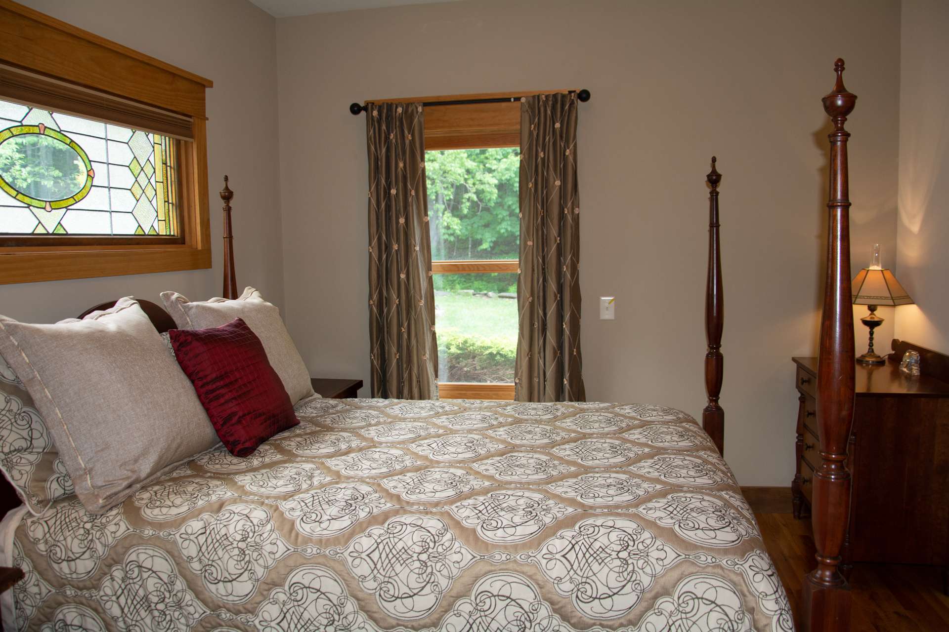 Also located on the main level is a guest bedroom with beautiful stained glass accents and full bath.