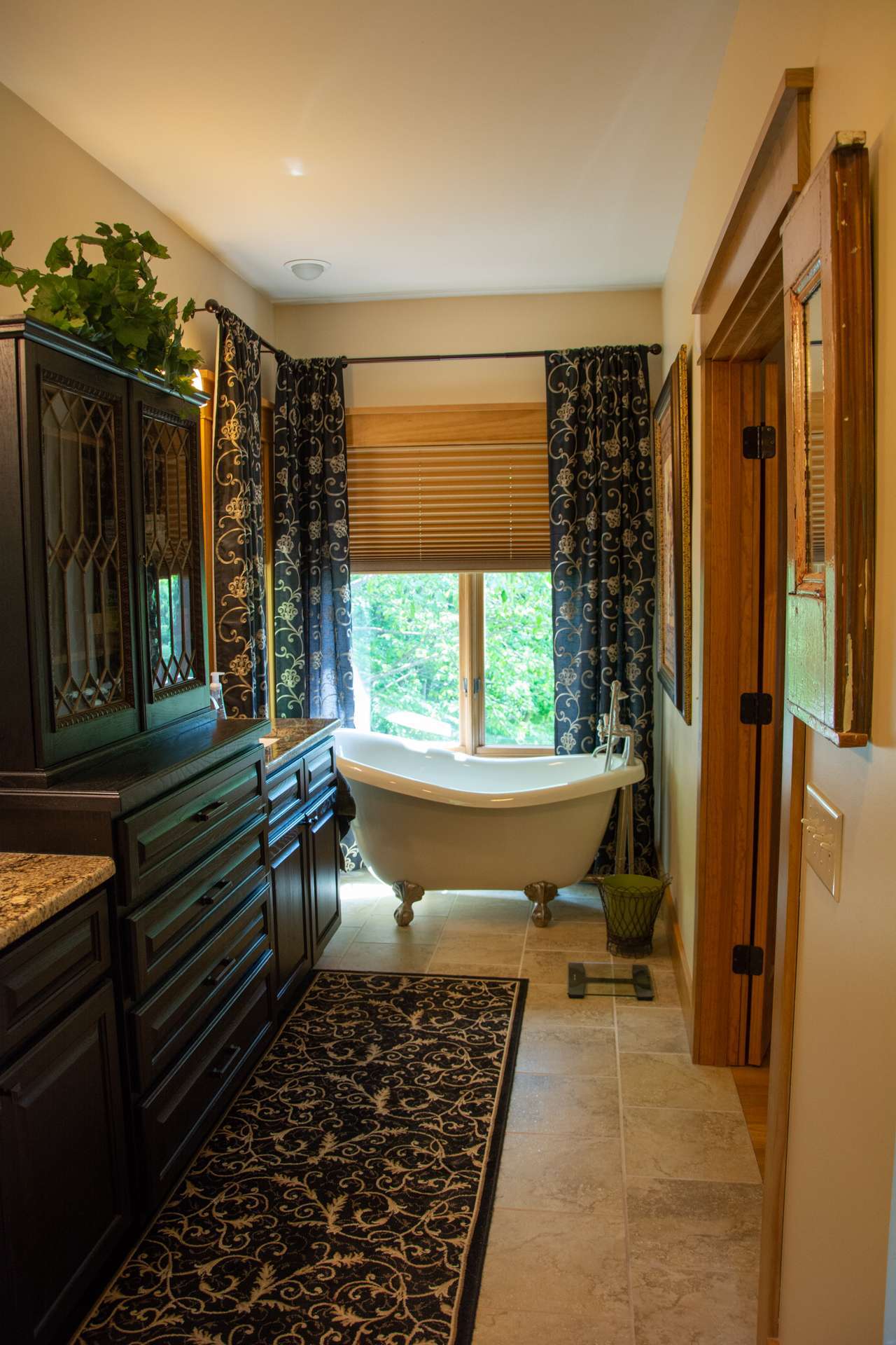 The master bath is a testament to luxury and comfort featuring his and hers vanities, tiled floor, clawfoot soaking tub and a separate walk-in tiled shower.