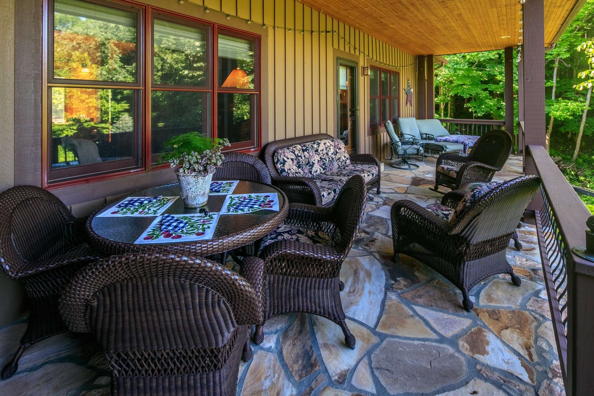 Walk out to the awe-inspiring outdoor entertaining area overlooking beautiful gardens, the pond, and views of Bluff Mountain.
